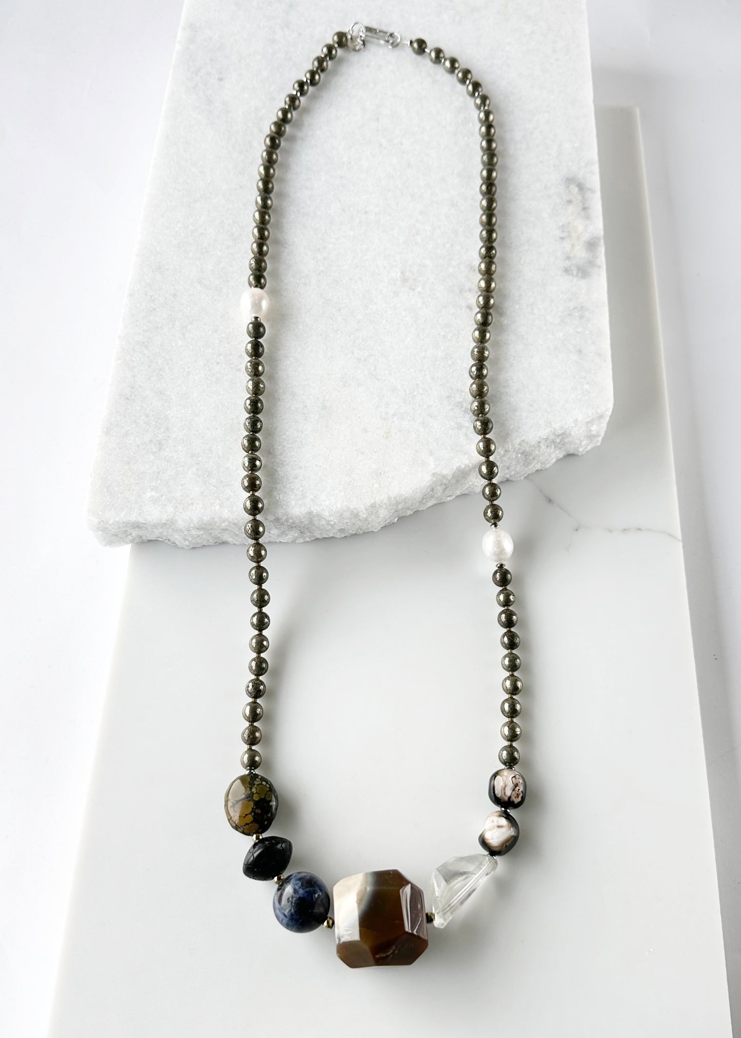 Stunning! This Long (39.5”) Necklace features Large Faceted Agate, Sodalite, Clear Quartz, Pyrite, Brown Turquoise, and Two Edison Pearls, Finished with a Charm Clasp.  This piece can be worn as is or Doubled.