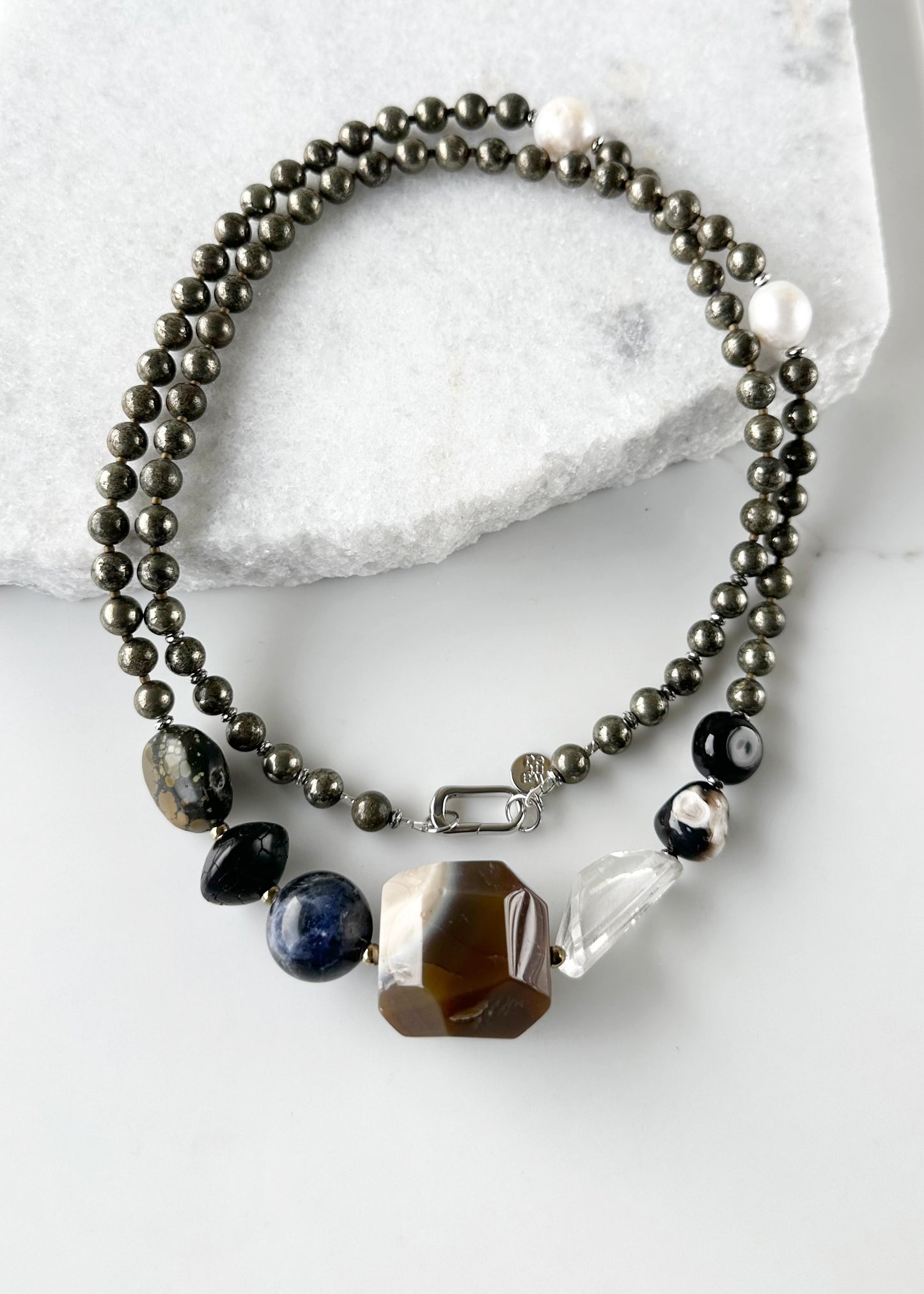 Stunning! This Long (39.5”) Necklace features Large Faceted Agate, Sodalite, Clear Quartz, Pyrite, Brown Turquoise, and Two Edison Pearls, Finished with a Charm Clasp.  This piece can be worn as is or Doubled.