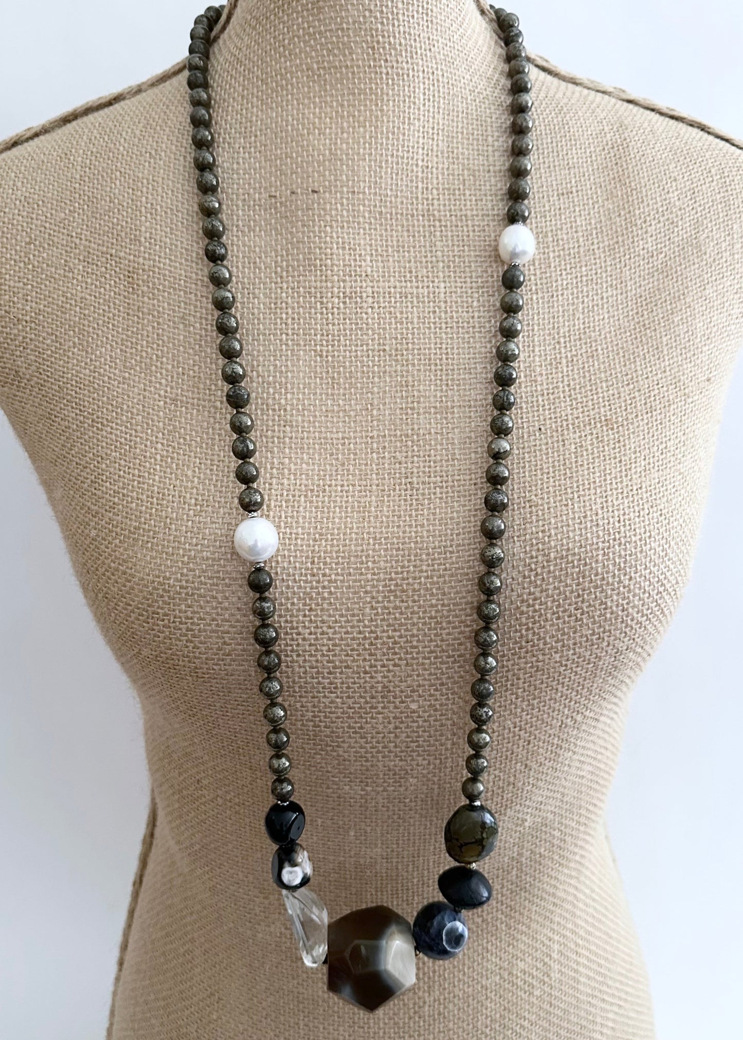 Stunning! This Long (39.5”) Necklace features Large Faceted Agate, Sodalite, Clear Quartz, Pyrite, Brown Turquoise, and Two Edison Pearls, Finished with a Charm Clasp.  This piece can be worn as is or Doubled.