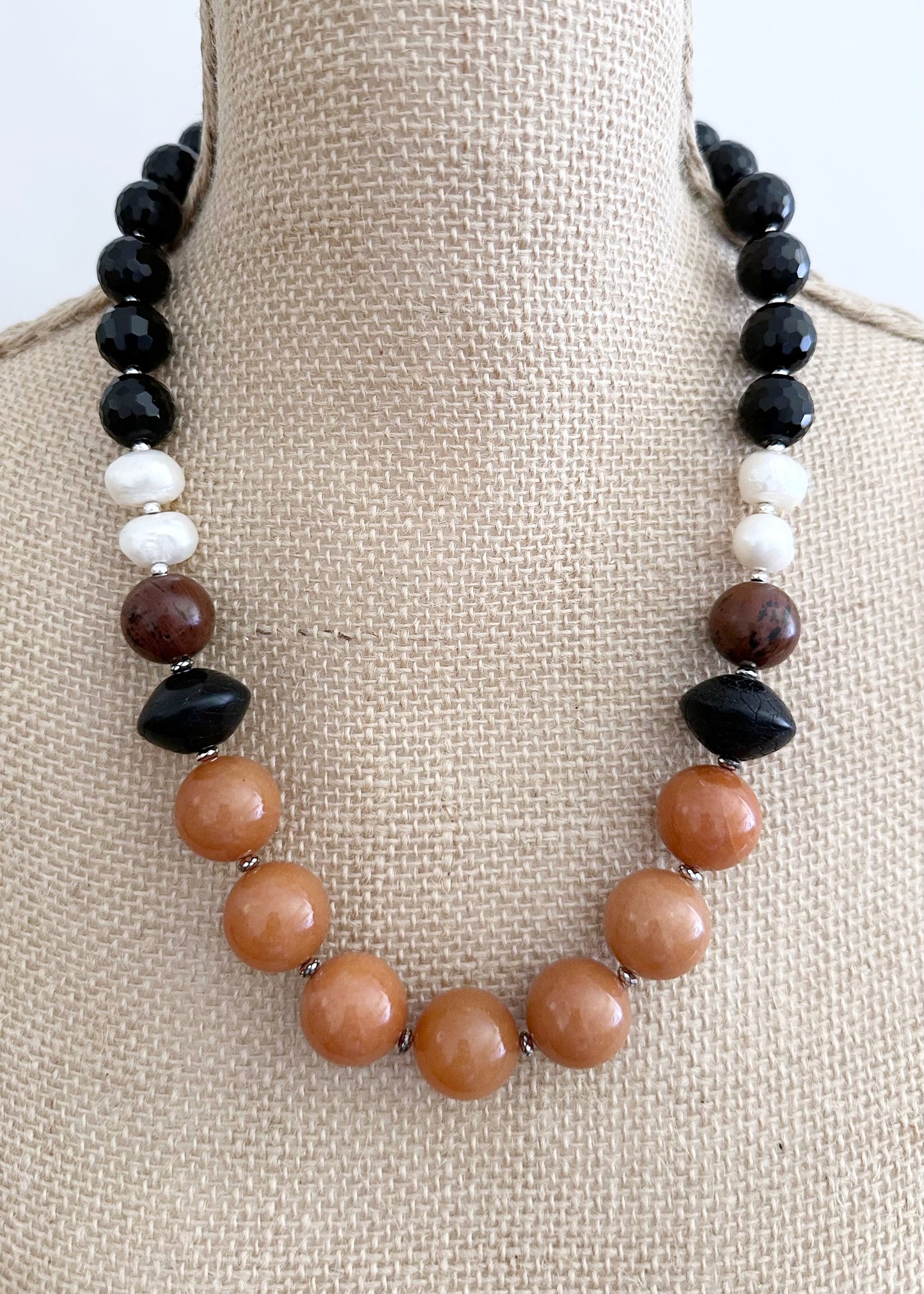 This One-Of-A-Kind 22.5” Necklace Features Large, Round, Orange Aventurine, Black Agate, Mahogany Obsidian and Pearls, Accented with Silver and Finished with a Sterling Silver Lobster Claw Clasp.