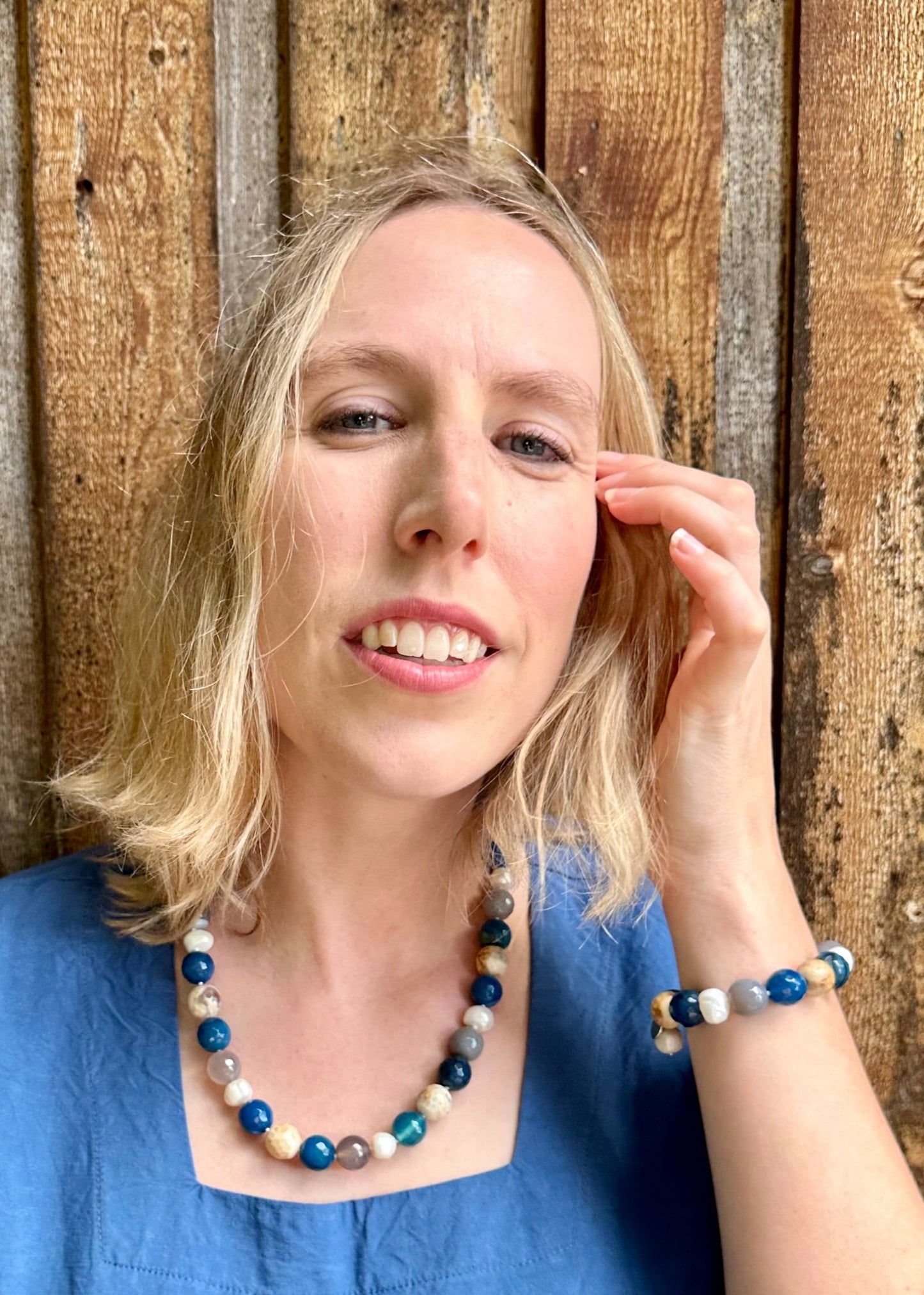 White Freshwater Pearl with Blue Semi-Precious Stone Mix Stretch Bracelet.  Perfect for layering! Shown on Model with Matching Necklace