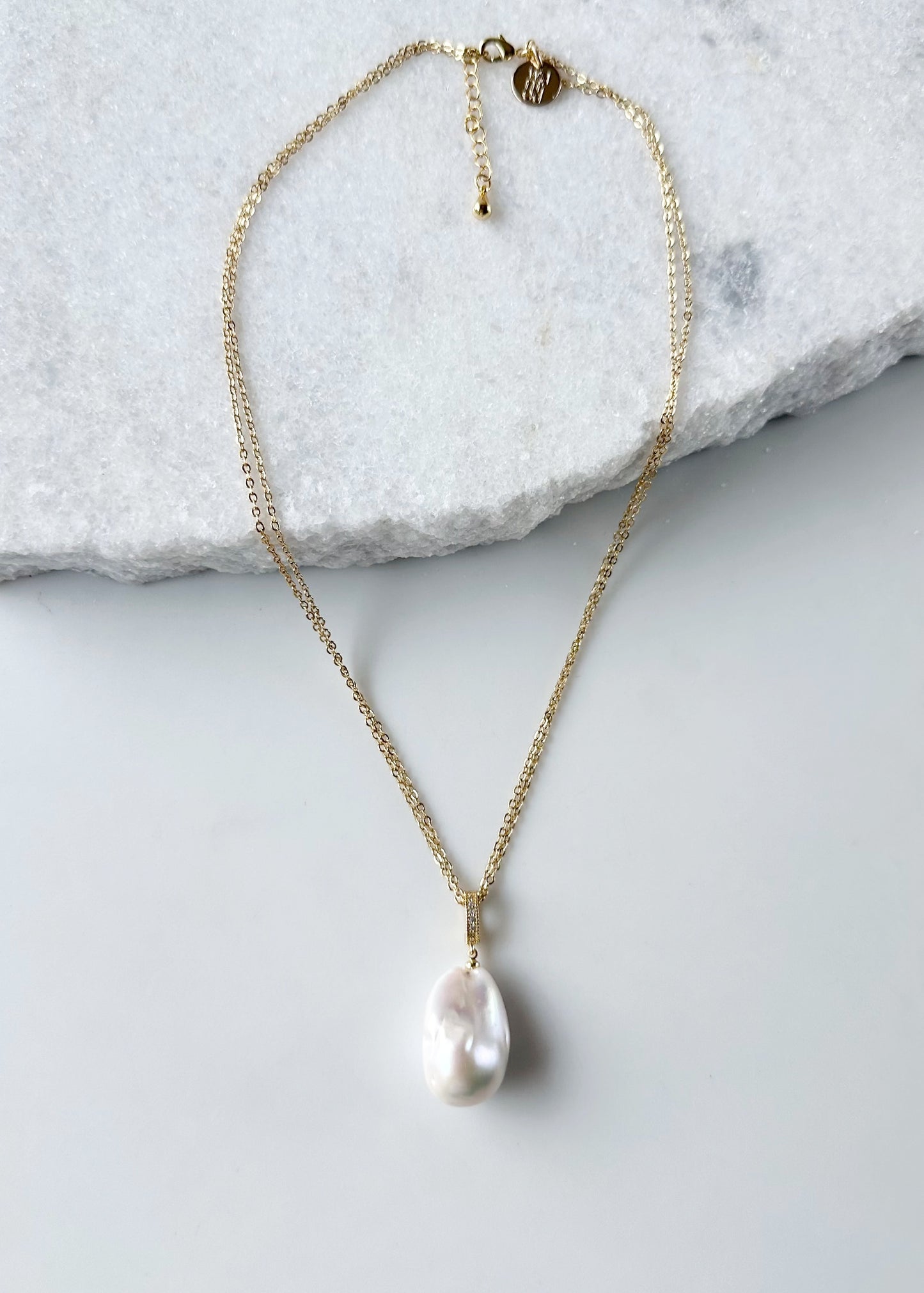 Large Baroque White Freshwater Pearl Pendant on Gold-Plated Bail with In-Laid Cubic Zirconia.  This Clip-On Pendant allows you to wear it with many of your favorite Pearl Necklaces. Here, shown on Gold-Plated Chain.