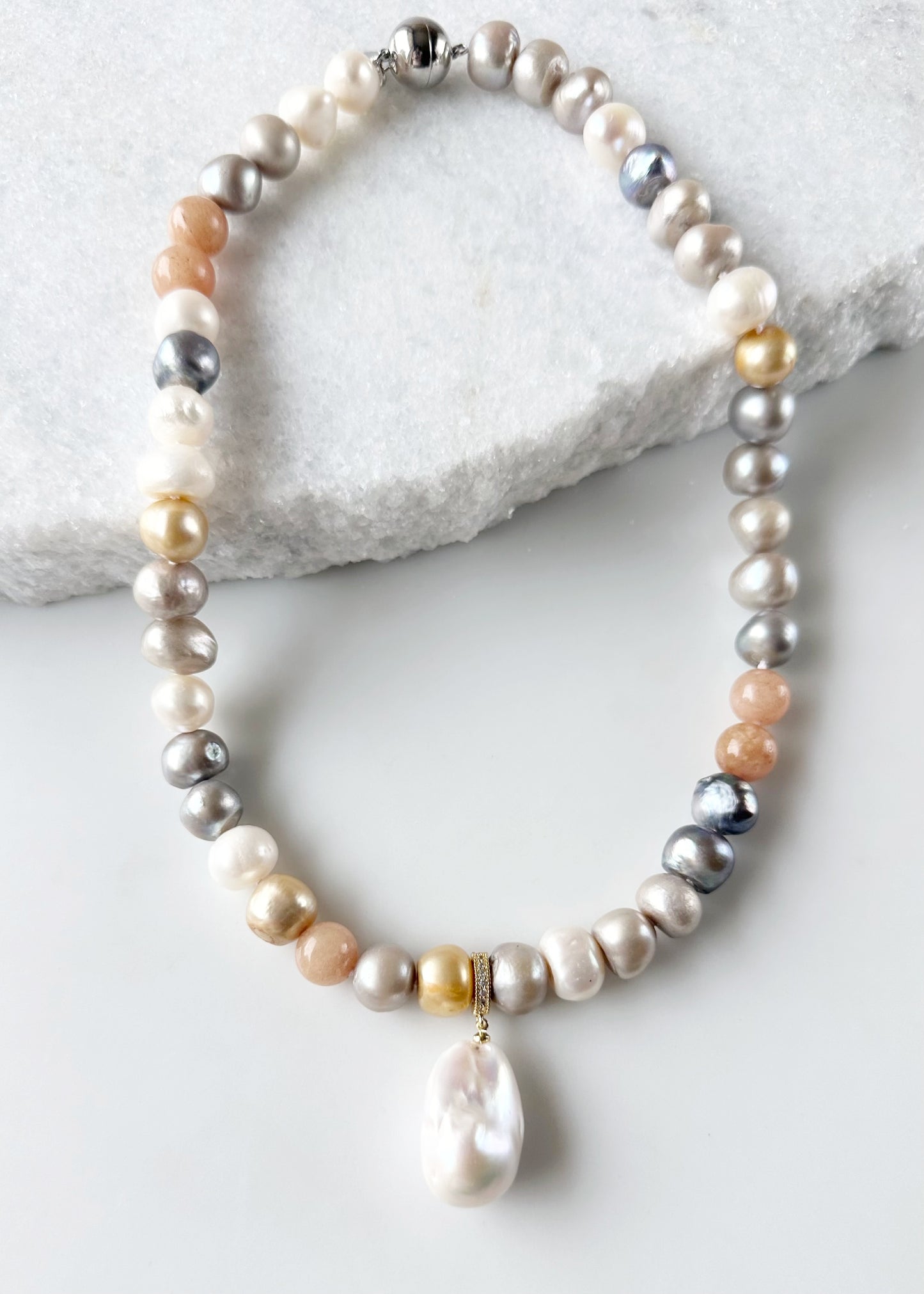 Large Baroque White Freshwater Pearl Pendant on Gold-Plated Bail with In-Laid Cubic Zirconia.  This Clip-On Pendant allows you to wear it with many of your favorite Pearl Necklaces. Here, shown on Mixed  Peach Bianca Pearl Necklace.