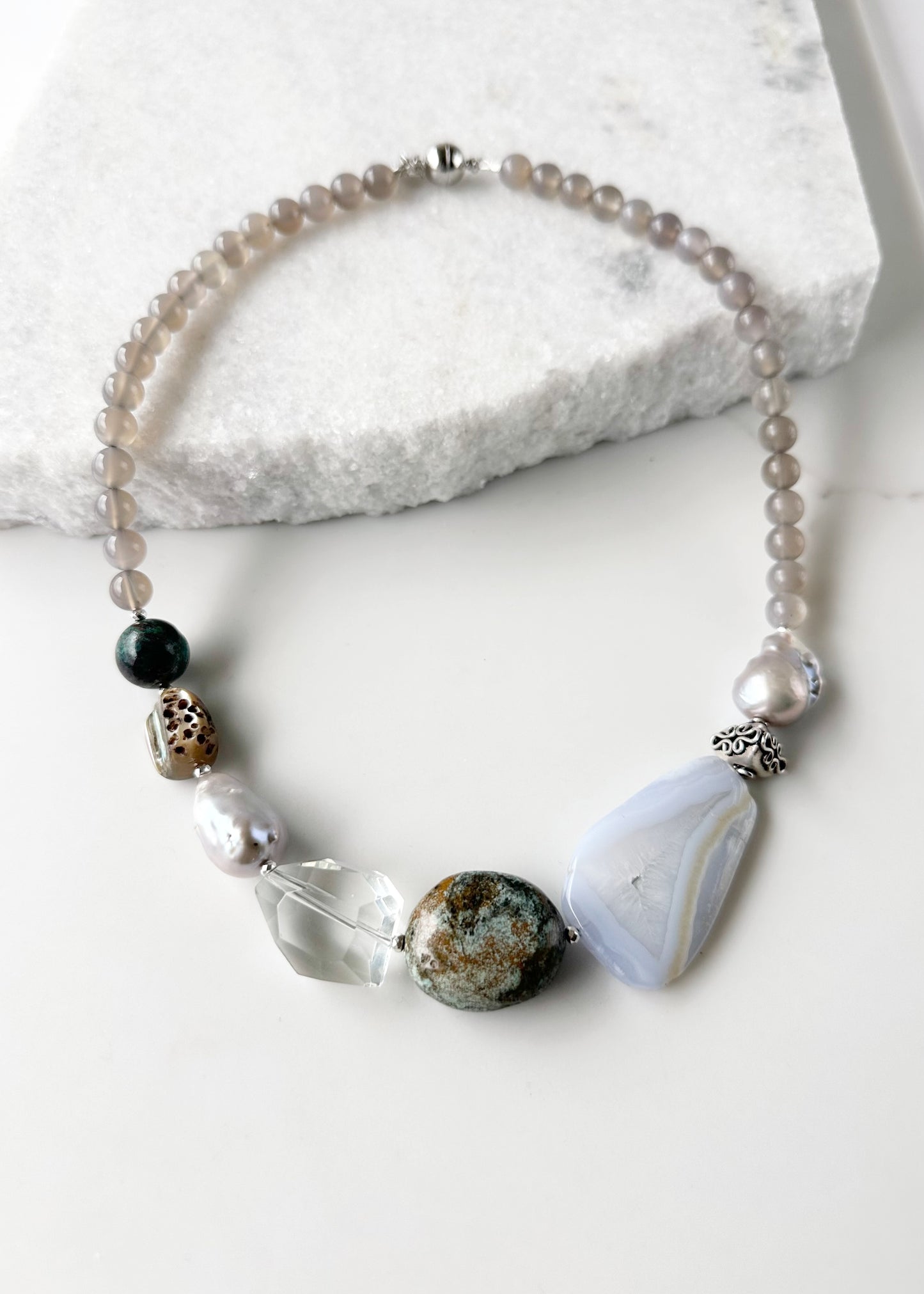 This Unique 20” Necklace Features Blue Lace & Grey Agate, Turquoise, Azurite Chrysocolla, Shell, Crystal, Beautiful Baroque Pearls and Finished with Silver Beads and a Strong Secure Magnetic Clasp for Easy Wear.