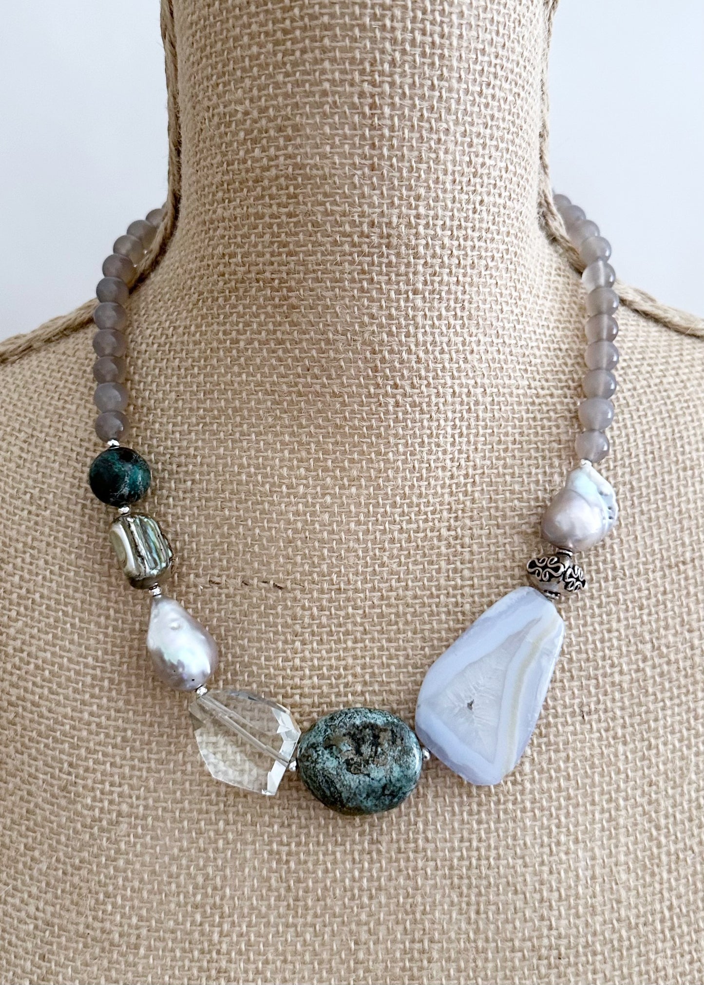 This Unique 20” Necklace Features Blue Lace & Grey Agate, Turquoise, Azurite Chrysocolla, Shell, Crystal, Beautiful Baroque Pearls and Finished with Silver Beads and a Strong Secure Magnetic Clasp for Easy Wear.