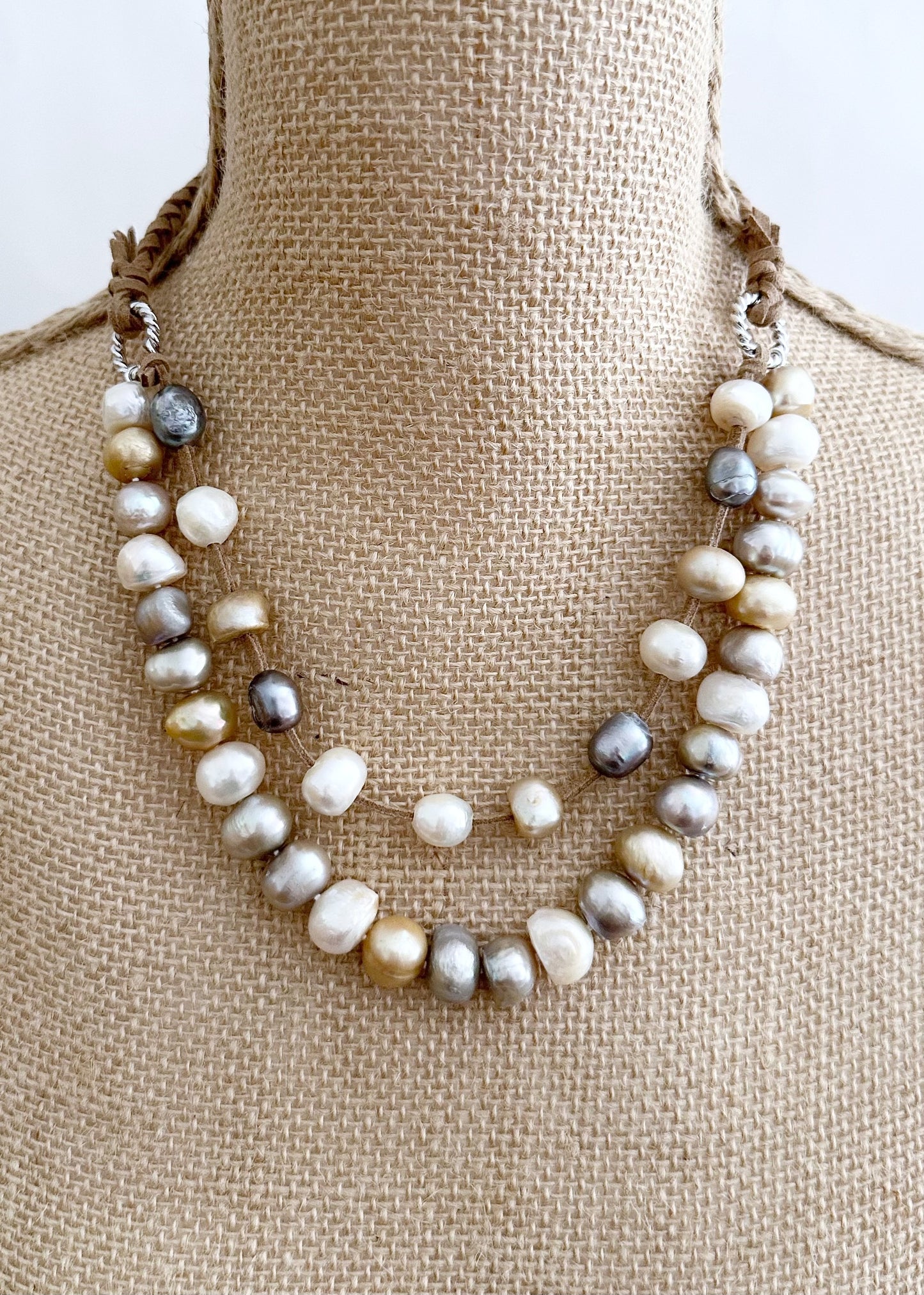 Two Strand White/Gold/Silver Freshwater Pearl Necklace, one Strand Knotted, the second Strand with Floating Pearls Held by a White Gold-Plated Ring.  A strong Secure Magnetic Clasp allows for Easy Wear. Shown on Bust