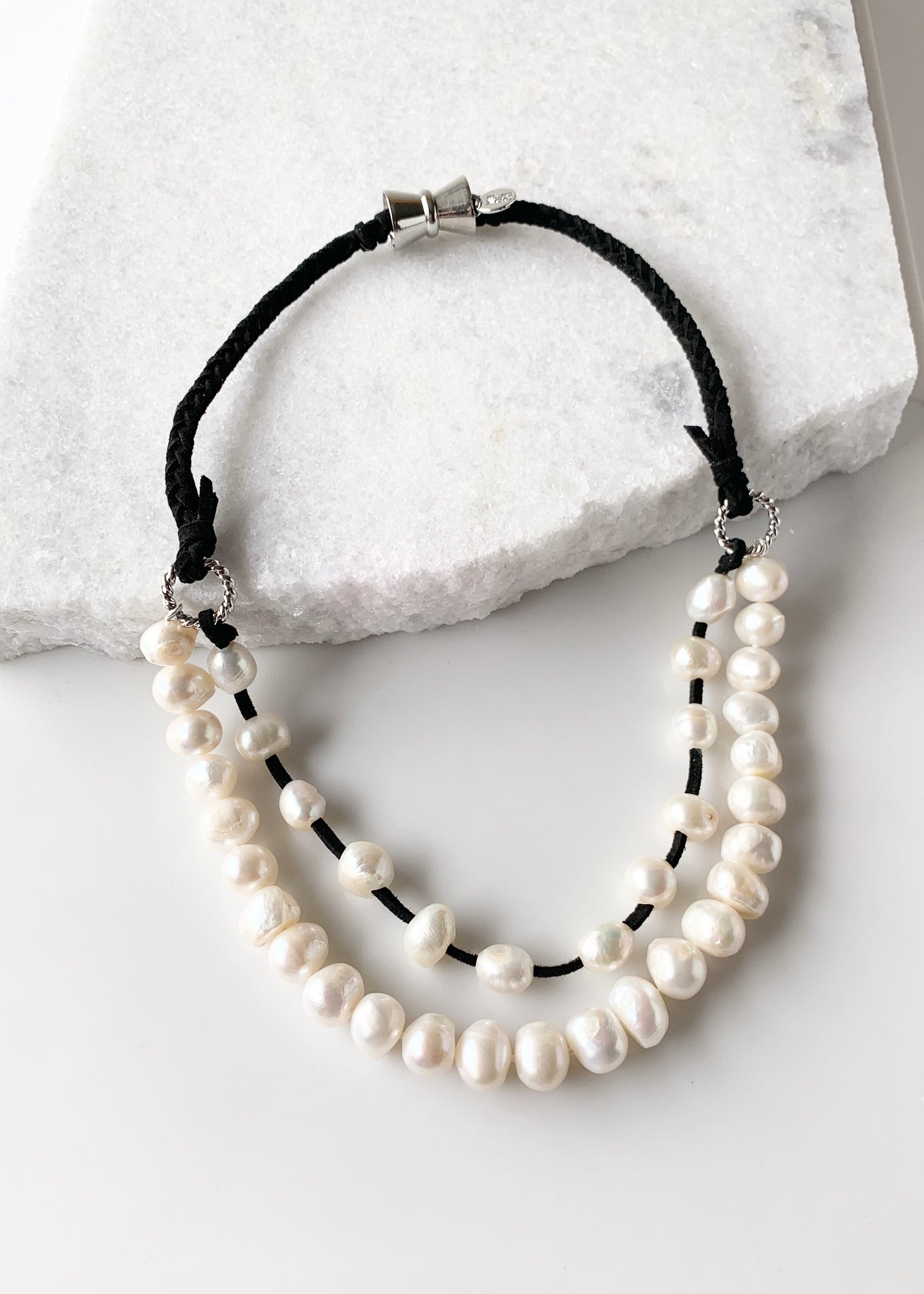 Two Strand White Freshwater Pearl Necklace, one Strand Knotted, the second Strand with Floating Pearls Held by a White Gold-Plated Ring.  A strong Secure Magnetic Clasp allows for Easy Wear.