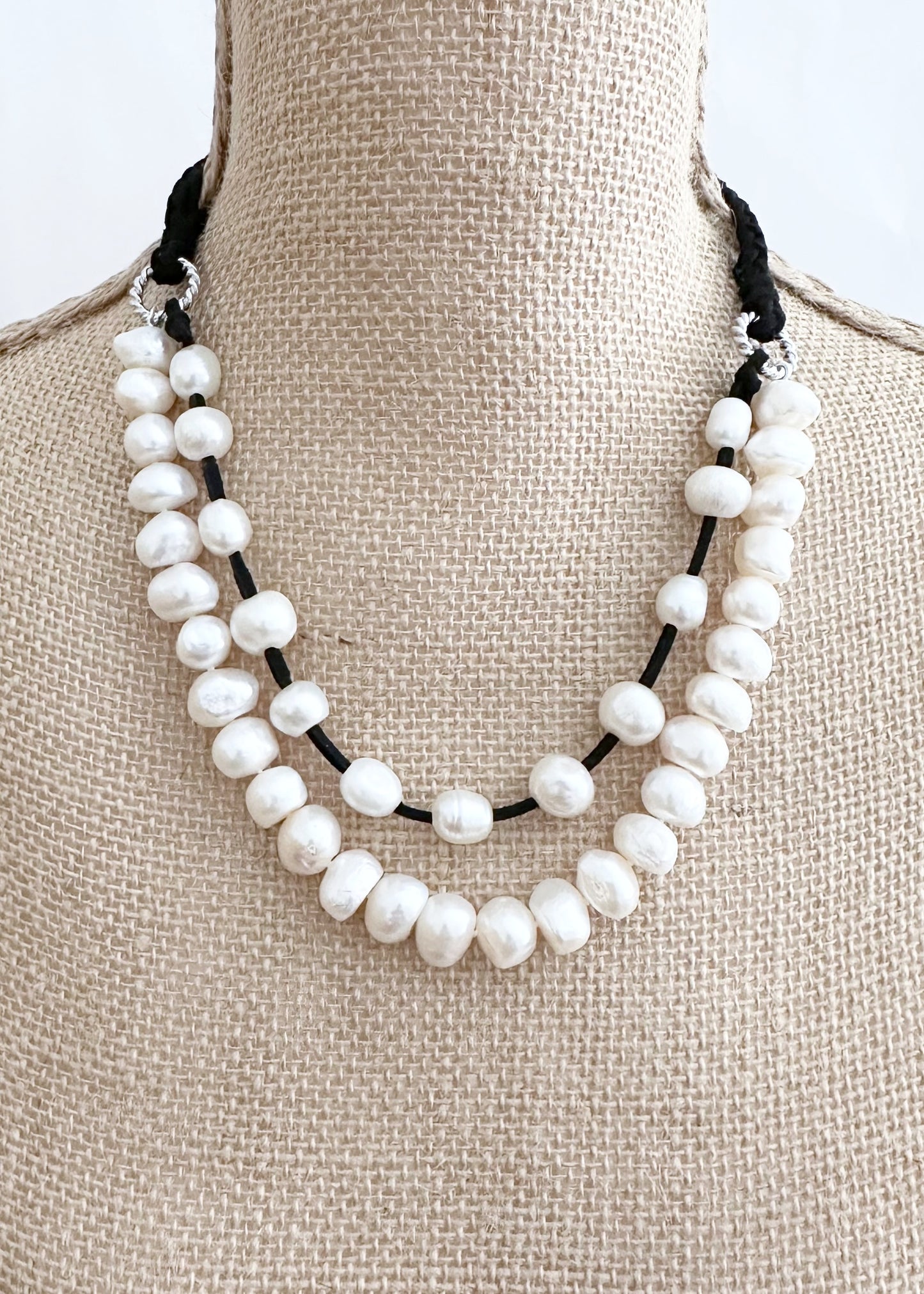 Two Strand White Freshwater Pearl Necklace, one Strand Knotted, the second Strand with Floating Pearls Held by a White Gold-Plated Ring.  A strong Secure Magnetic Clasp allows for Easy Wear. Shown on Bust