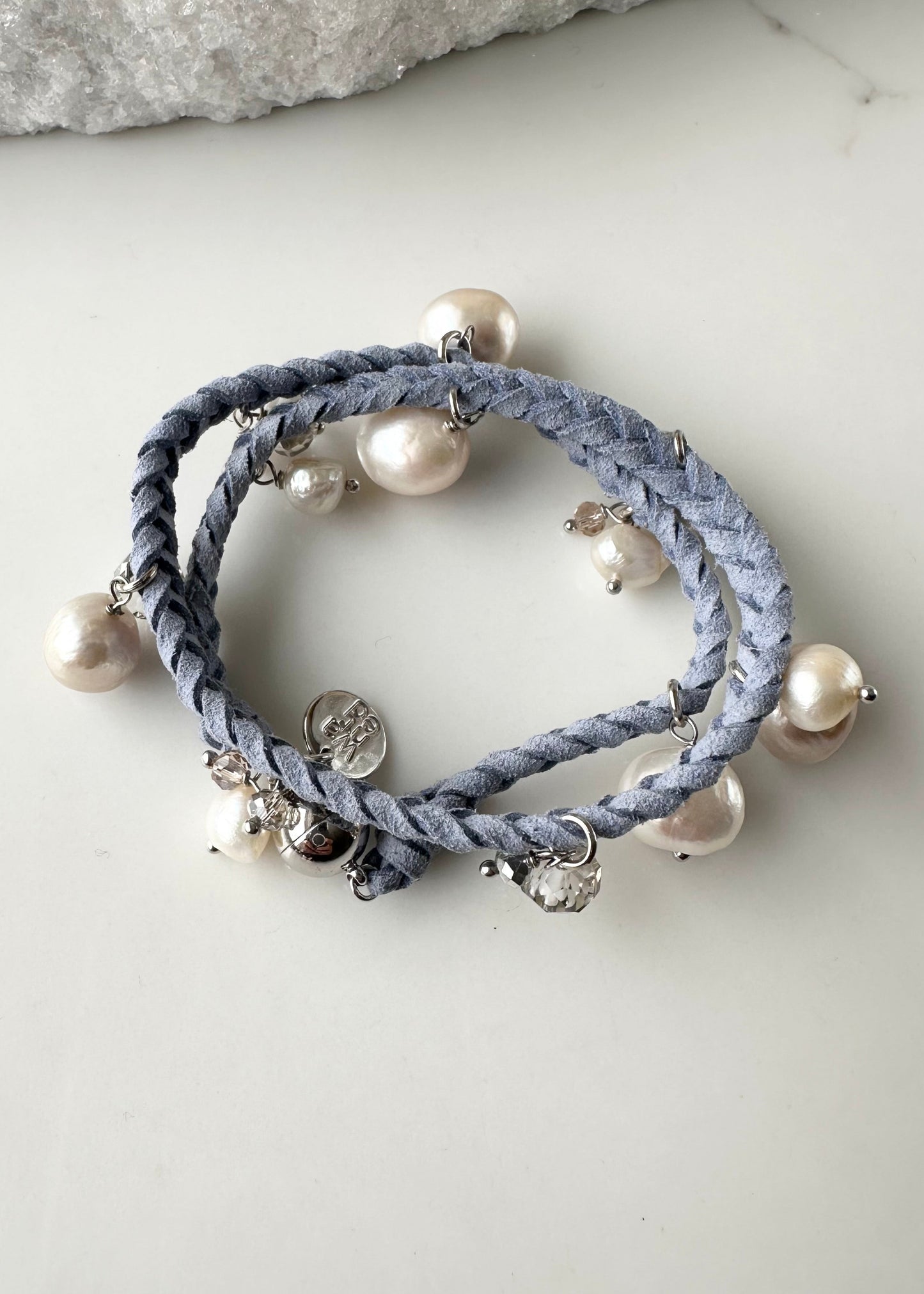 White and Champagne Baroque, Freshwater Pearls hang from this 14” Double Wrap Bracelet made of Vegan Suede in Blue.  The piece is completed with crystal accents and a Strong Secure Magnetic Clasp for Easy Wear.