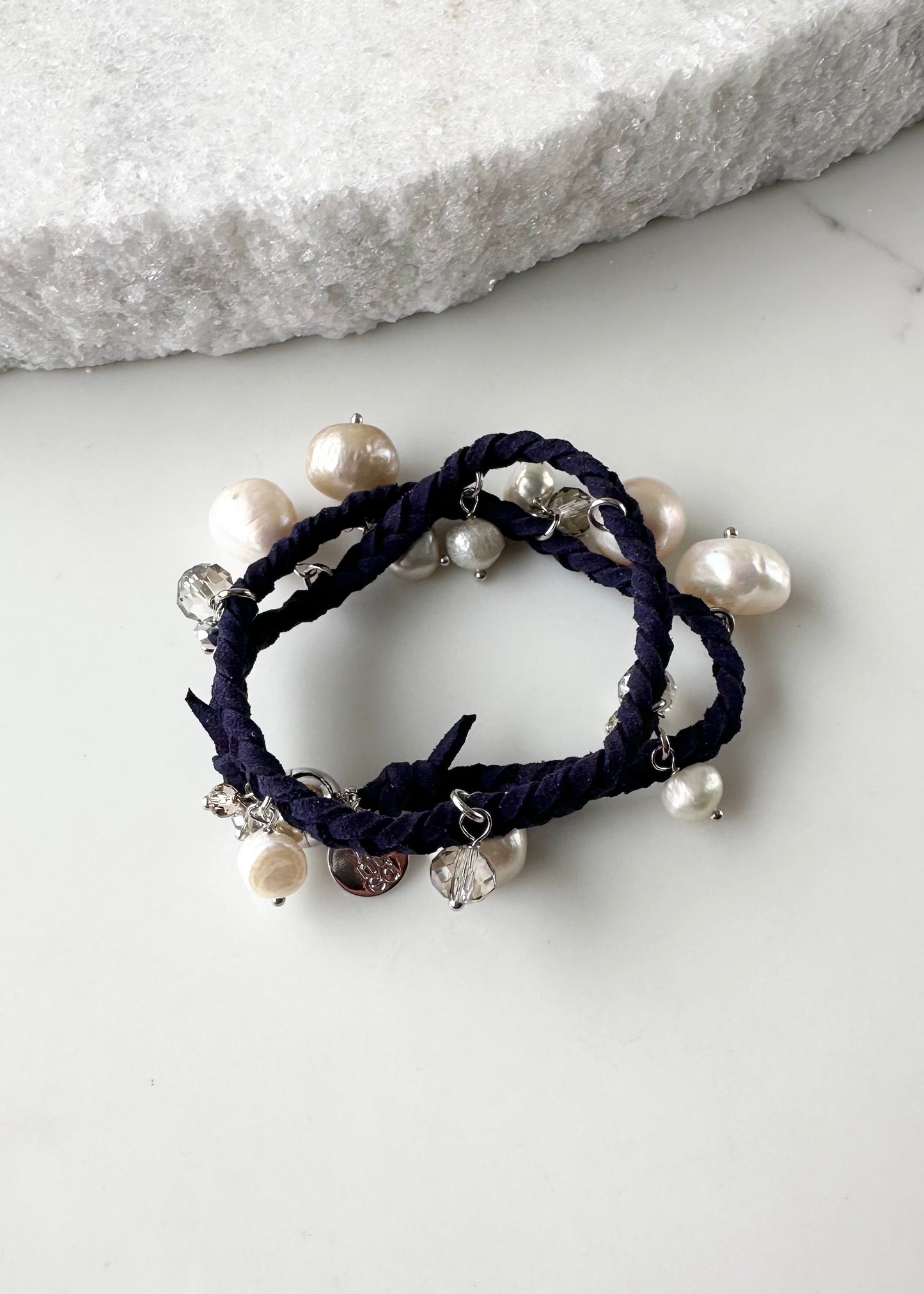 White and Champagne Baroque, Freshwater Pearls hang from this 14” Double Wrap Bracelet made of Vegan Suede in Navy.  The piece is completed with crystal accents and a Strong Secure Magnetic Clasp for Easy Wear.