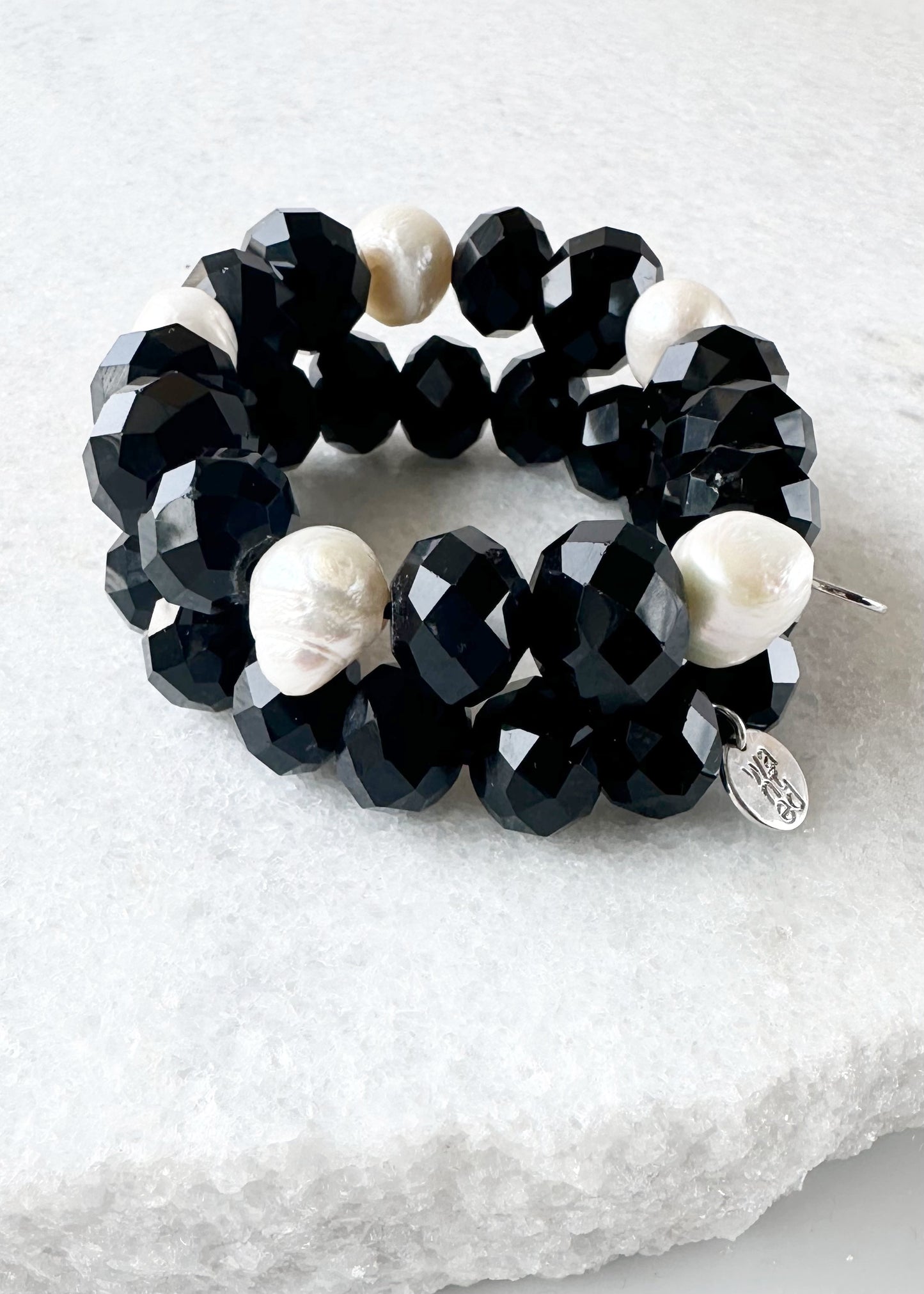 White Freshwater Pearls are joined by Black Faceted Crystals in the Stretch Bracelet. Two shown