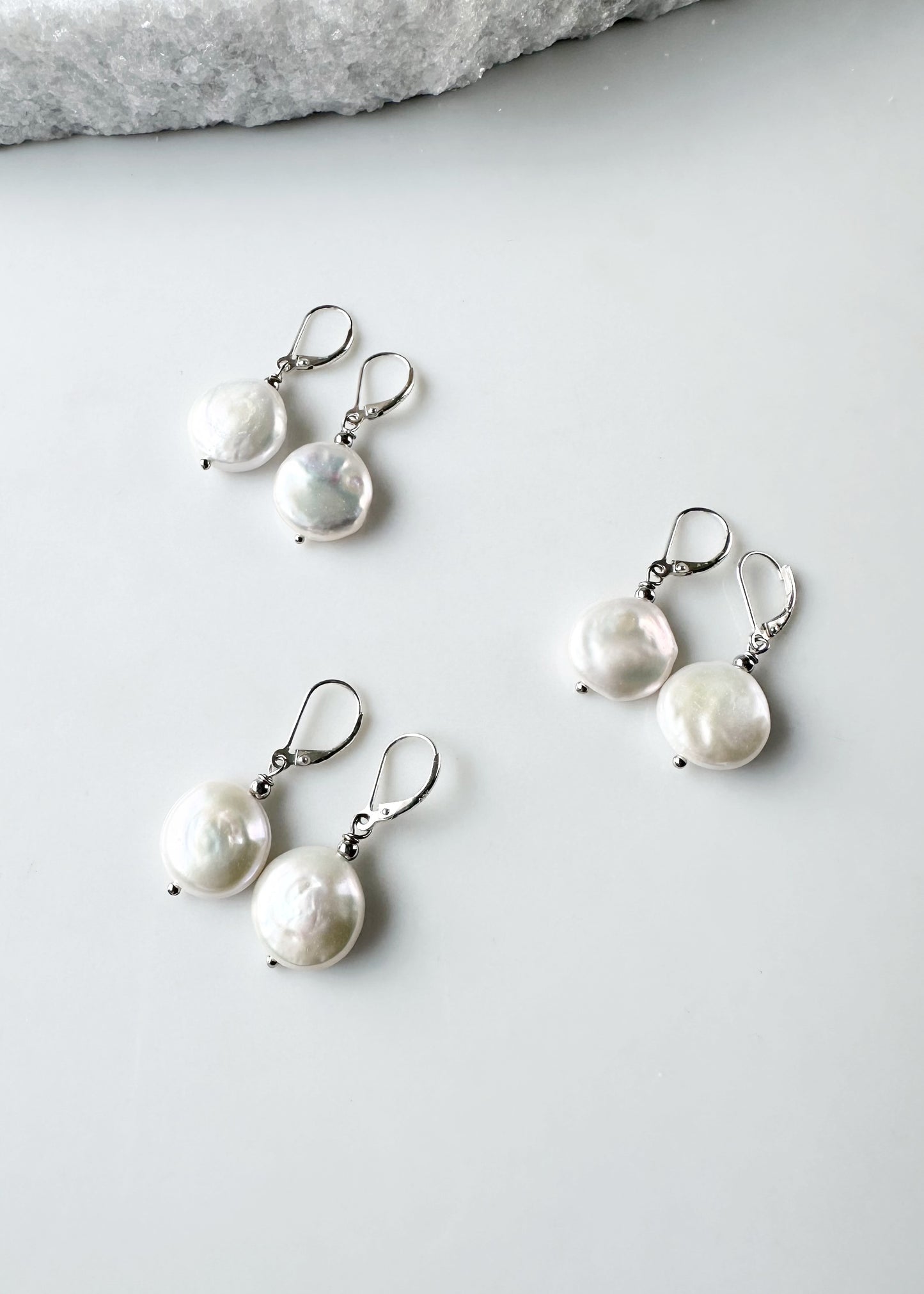 White Freshwater Coin Pearl Earrings with white crystal bead on Sterling Silver Lever backs. Three Pairs are Shown.
