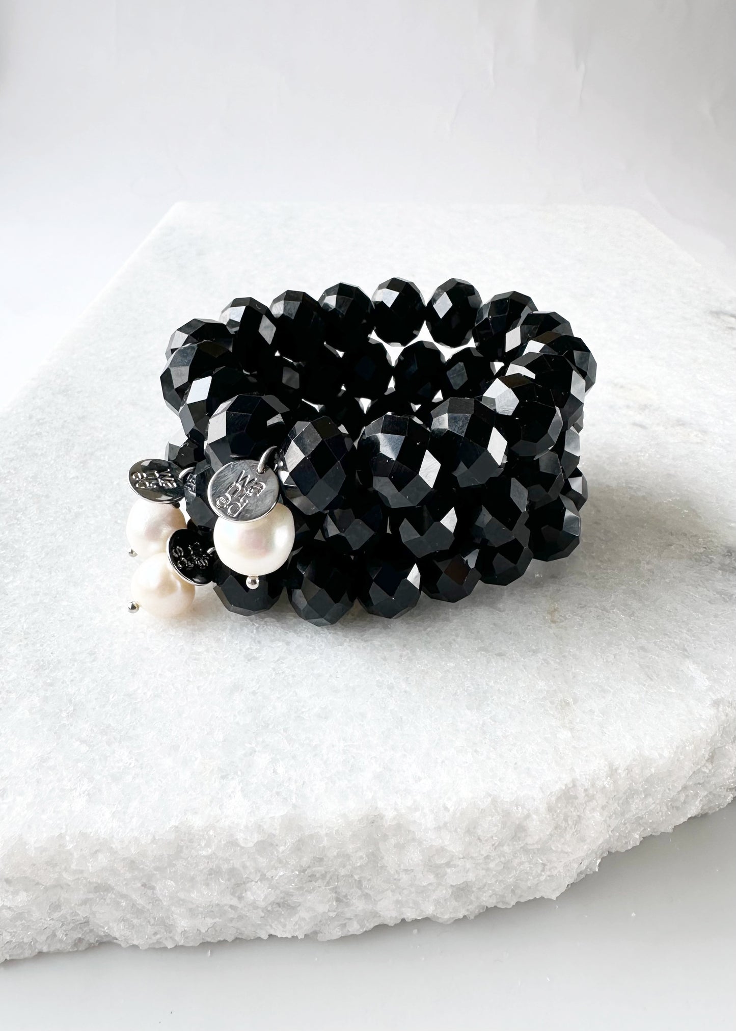 Stretch Bracelet of Large Faceted Black Crystals Accented with a White Freshwater Pearl Dangle. Stacked