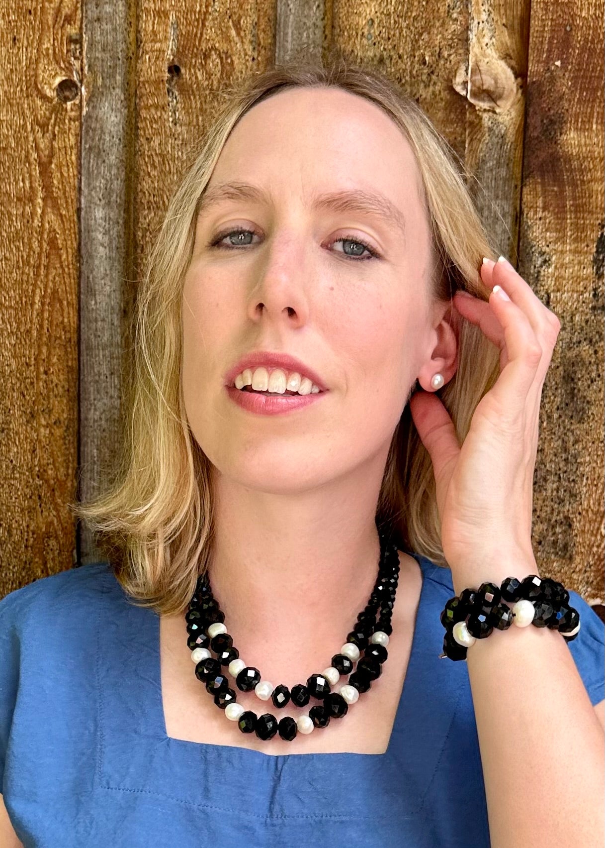 Two Strand White Freshwater Pearl Necklace with Large Faceted Black Crystals Joined by a Strong Secure Magnetic Clasp for Easy Wear.  Worn by Model with Matching Bracelet