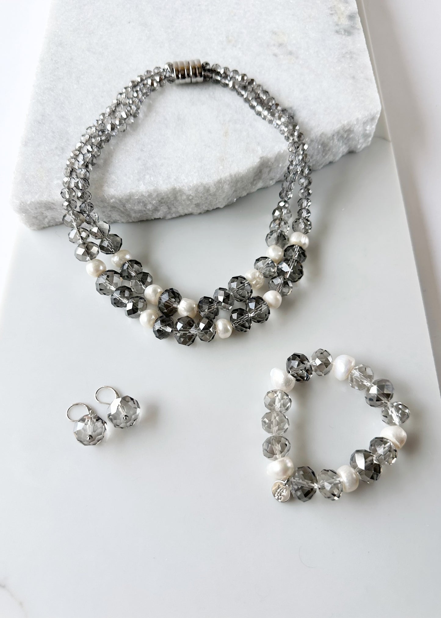 Two Strand White Freshwater Pearl Necklace with Large Faceted Smoke Crystals Joined by a Strong Secure Magnetic Clasp for Easy Wear.  Shown with Matching Bracelet and Earrings.