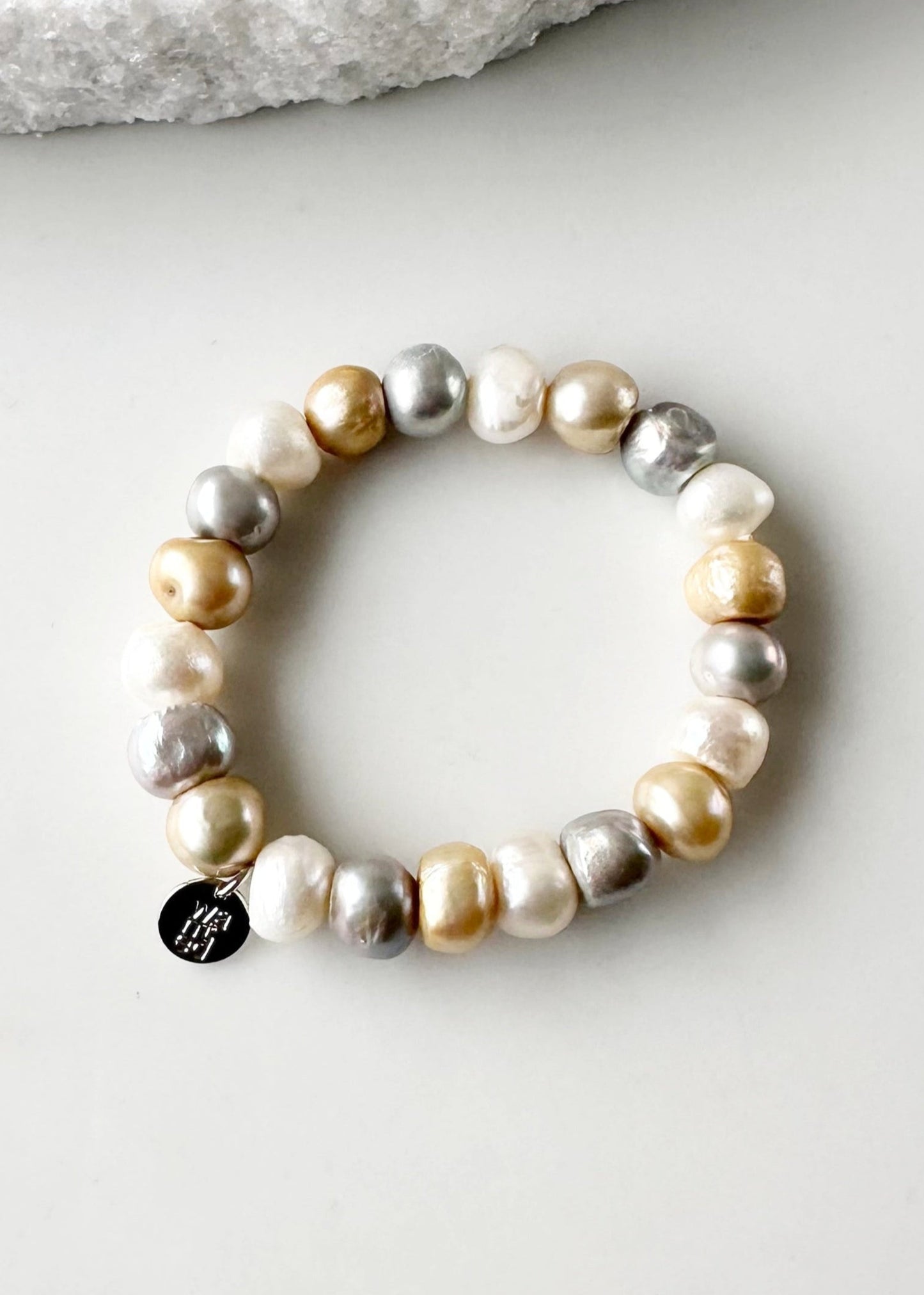 Mix of Large Baroque White, Gold and Silver Freshwater Pearls are designed in this Stretch Bracelet. This can be worn by itself or Stacked with others.