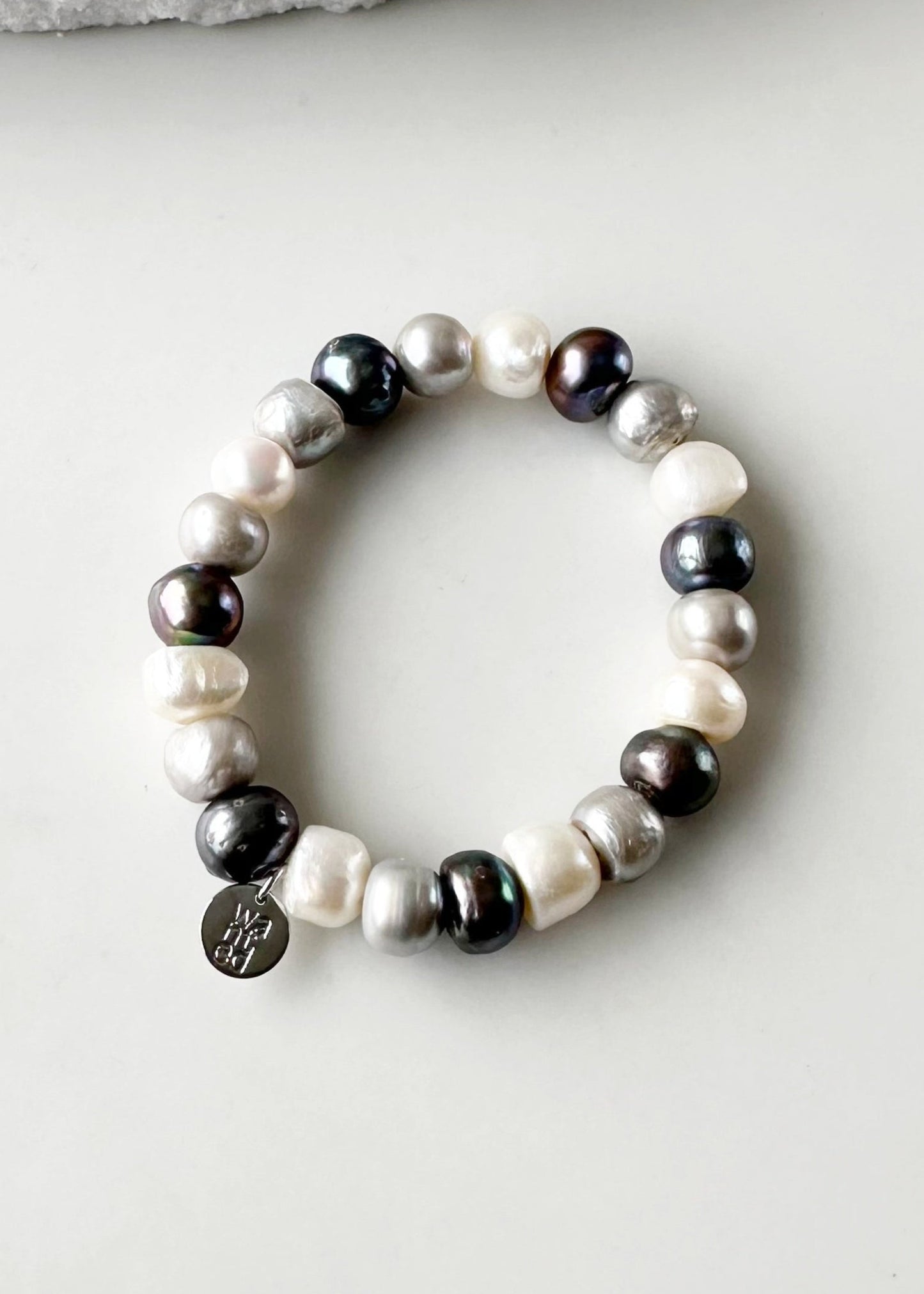 Mix of Large Baroque White, Silver and Black Freshwater Pearls are designed in this Stretch Bracelet. This can be worn by itself or Stacked with others.