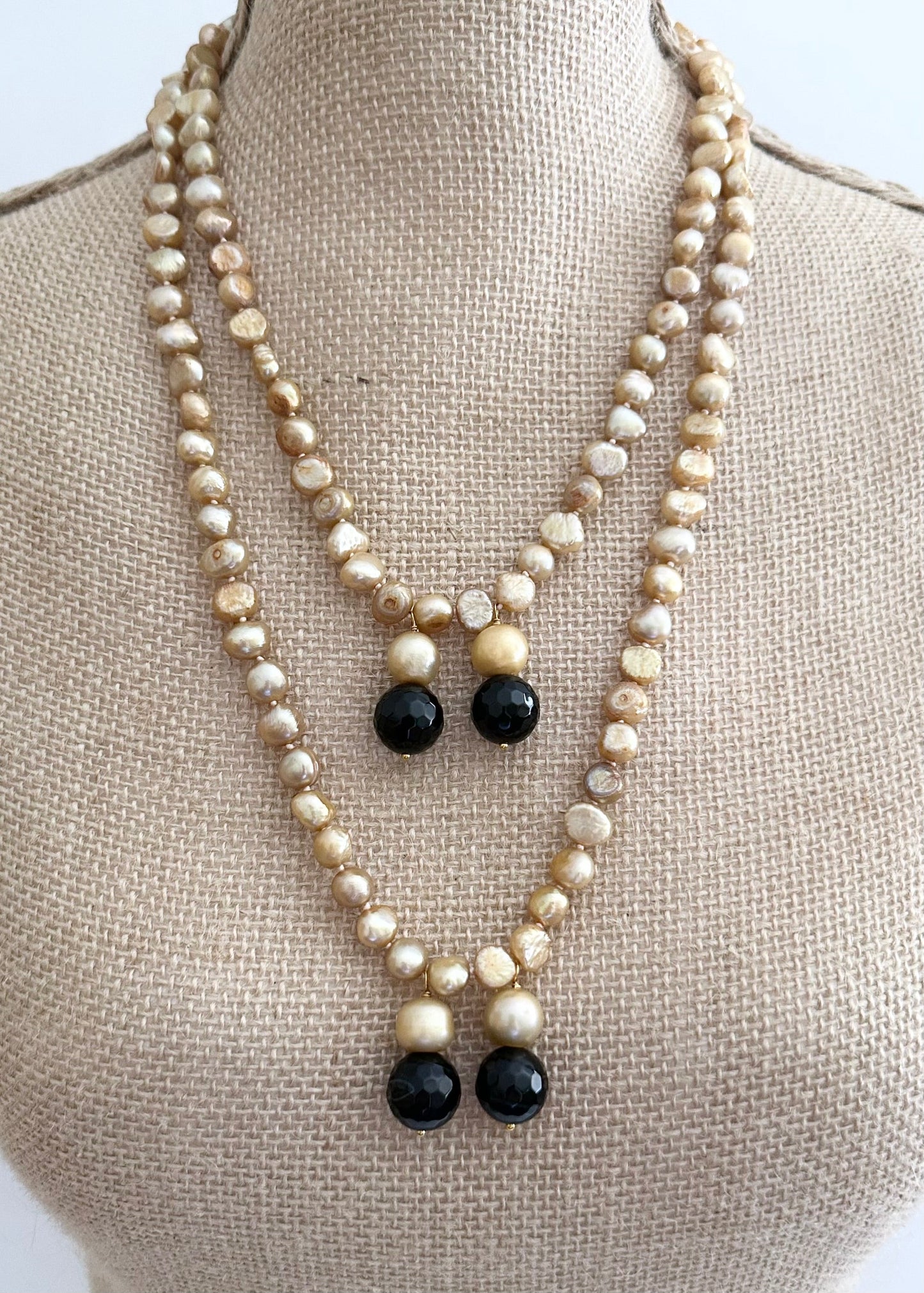 Long Generous Gold Freshwater Pearl Necklace with Larger Pearl and Black Agate drops.  Can be worn in many Styles.