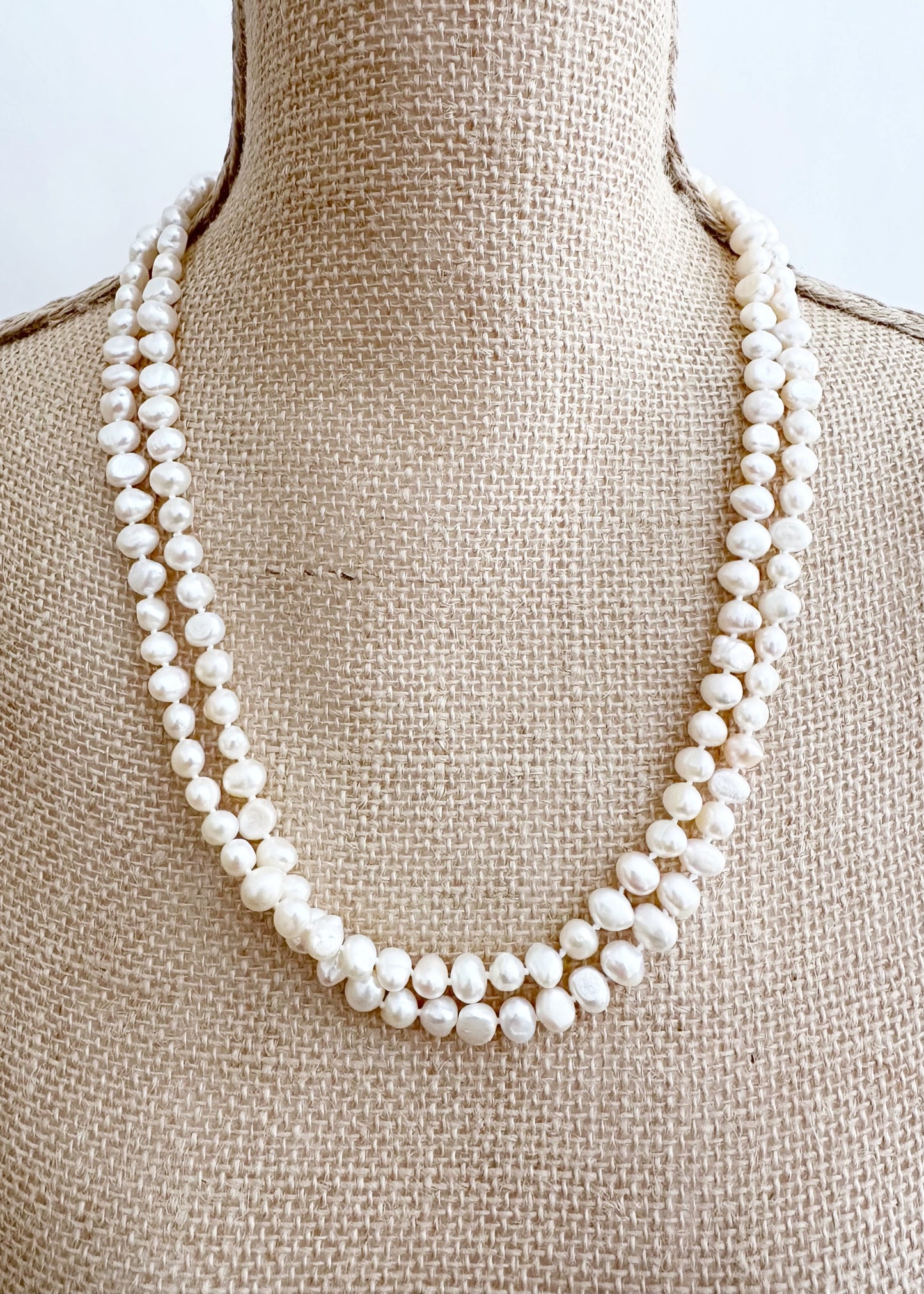 Long Necklace in White Baroque Freshwater Pearls. Wear as long Single strand or Doubled. On Bust