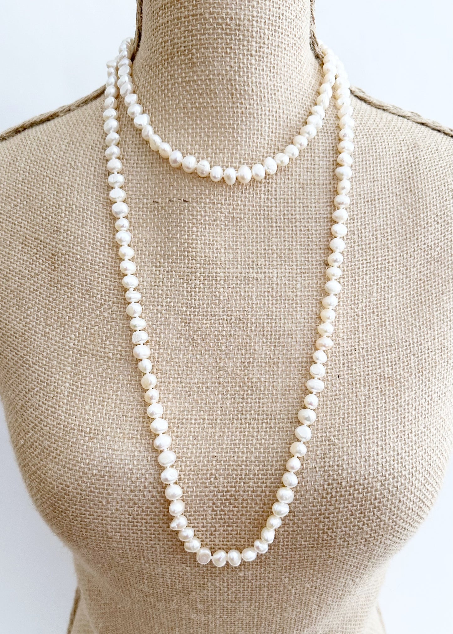 Long Necklace in White Baroque Freshwater Pearls. Wear as long Single strand or Doubled. On Bust