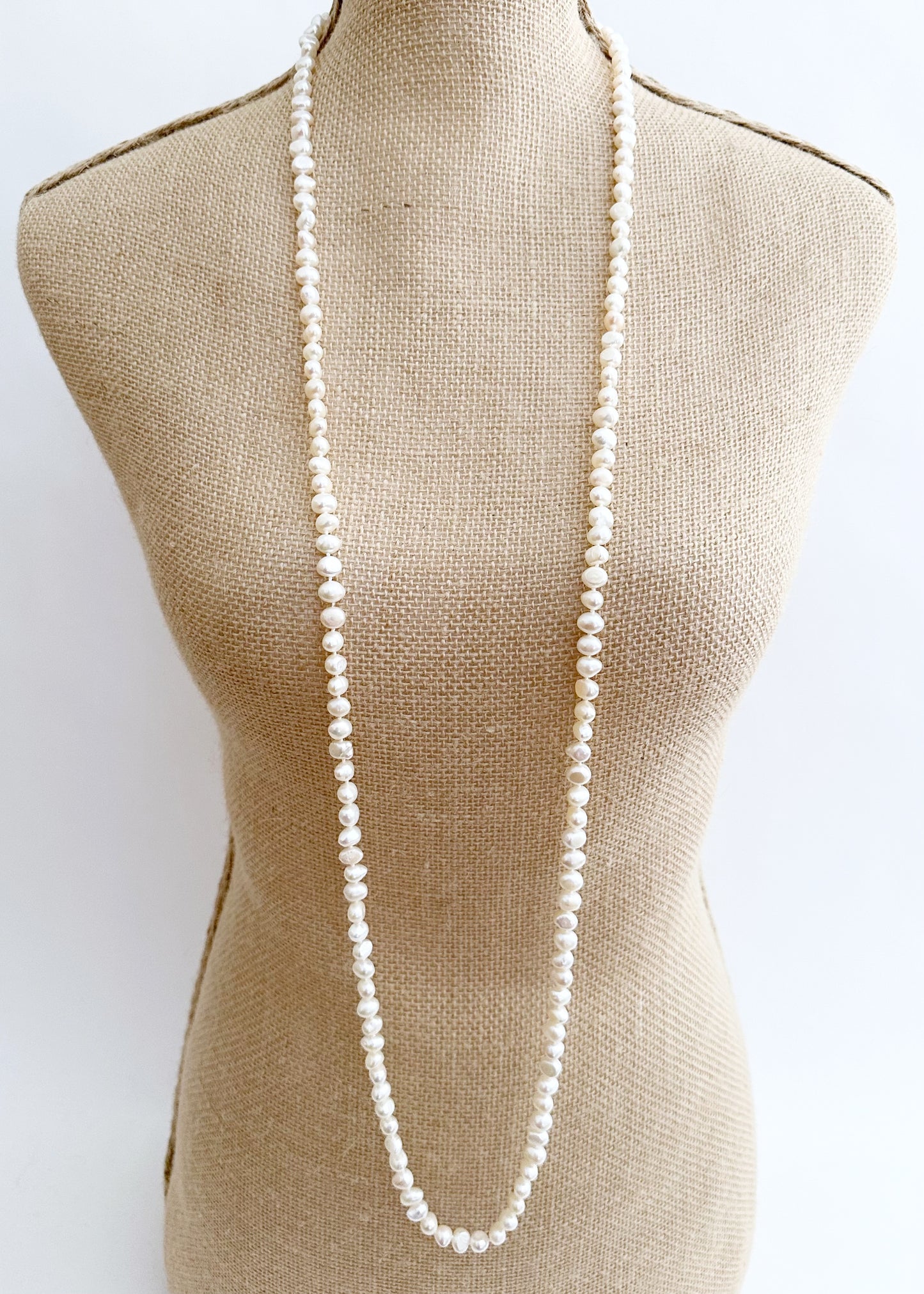 Long Necklace in White Baroque Freshwater Pearls. Wear as long Single strand or Doubled. On Bust