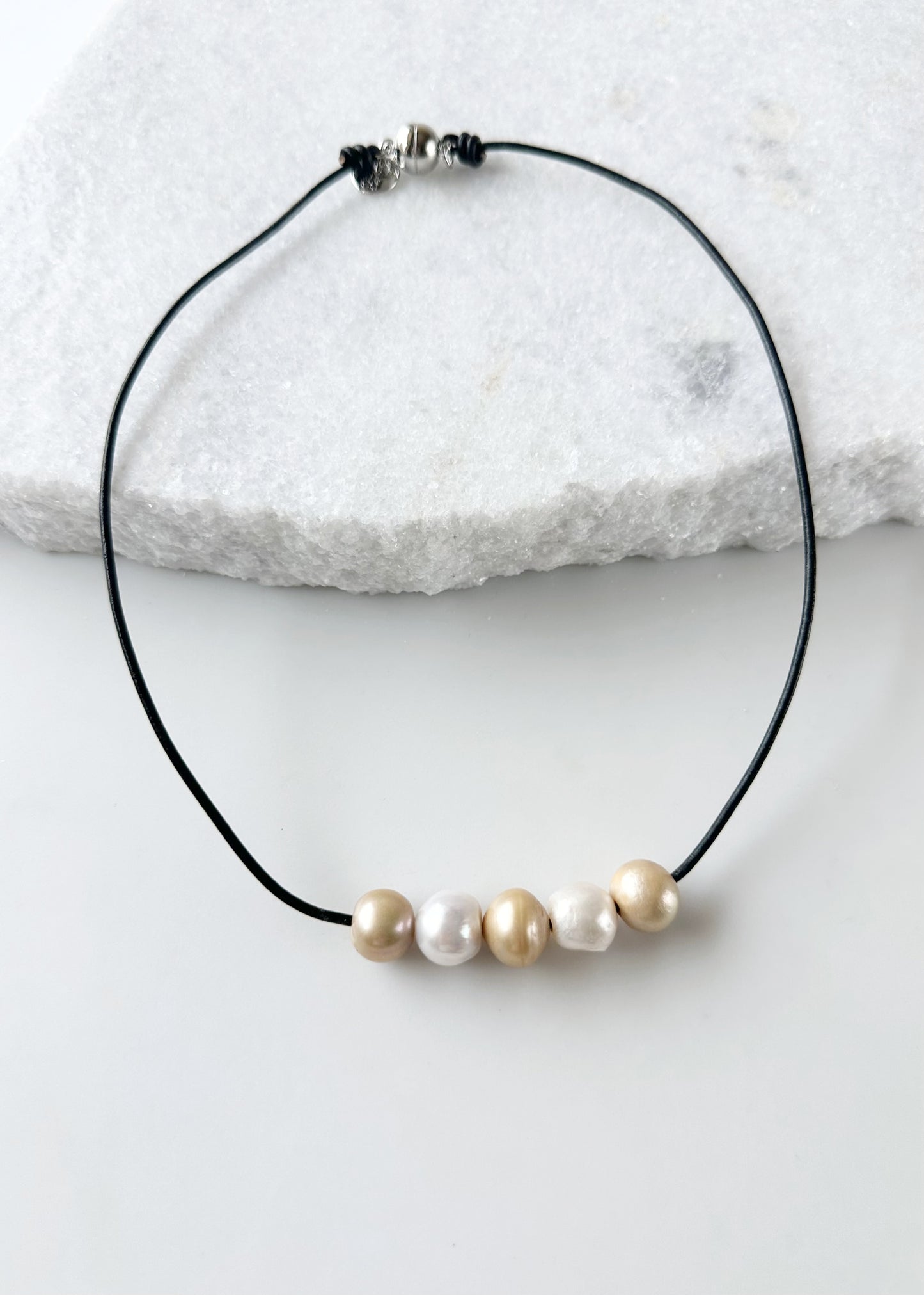 Five Large Gold and White Freshwater Pearls Floating on Black Leather secured by a Strong Magnetic Clasp for Easy wear.