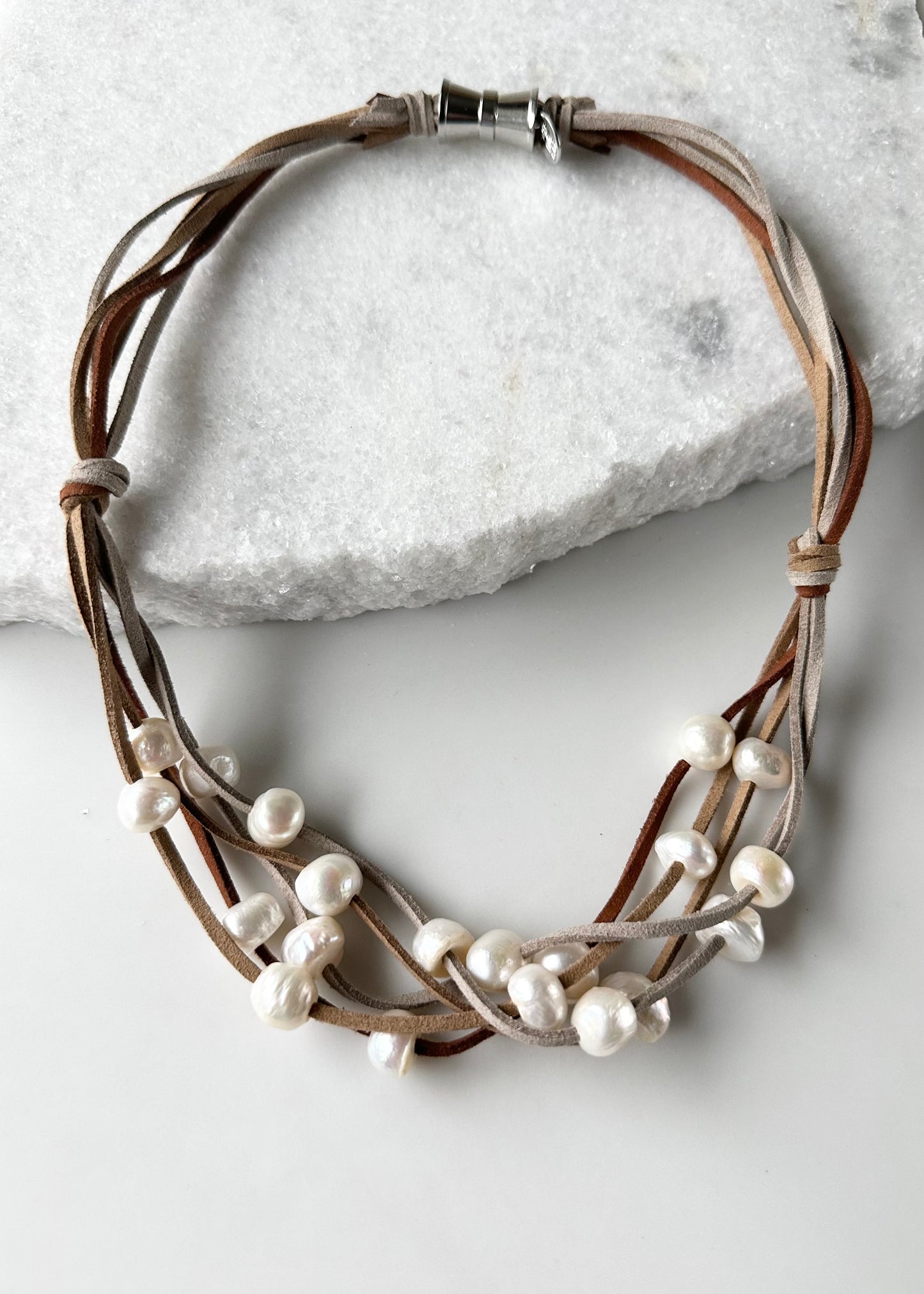 Five Strands of Brown Vegan Suede with Floating White Freshwater Pearls are Offered with a Strong Secure Magnetic Clasp for Easy Wear.