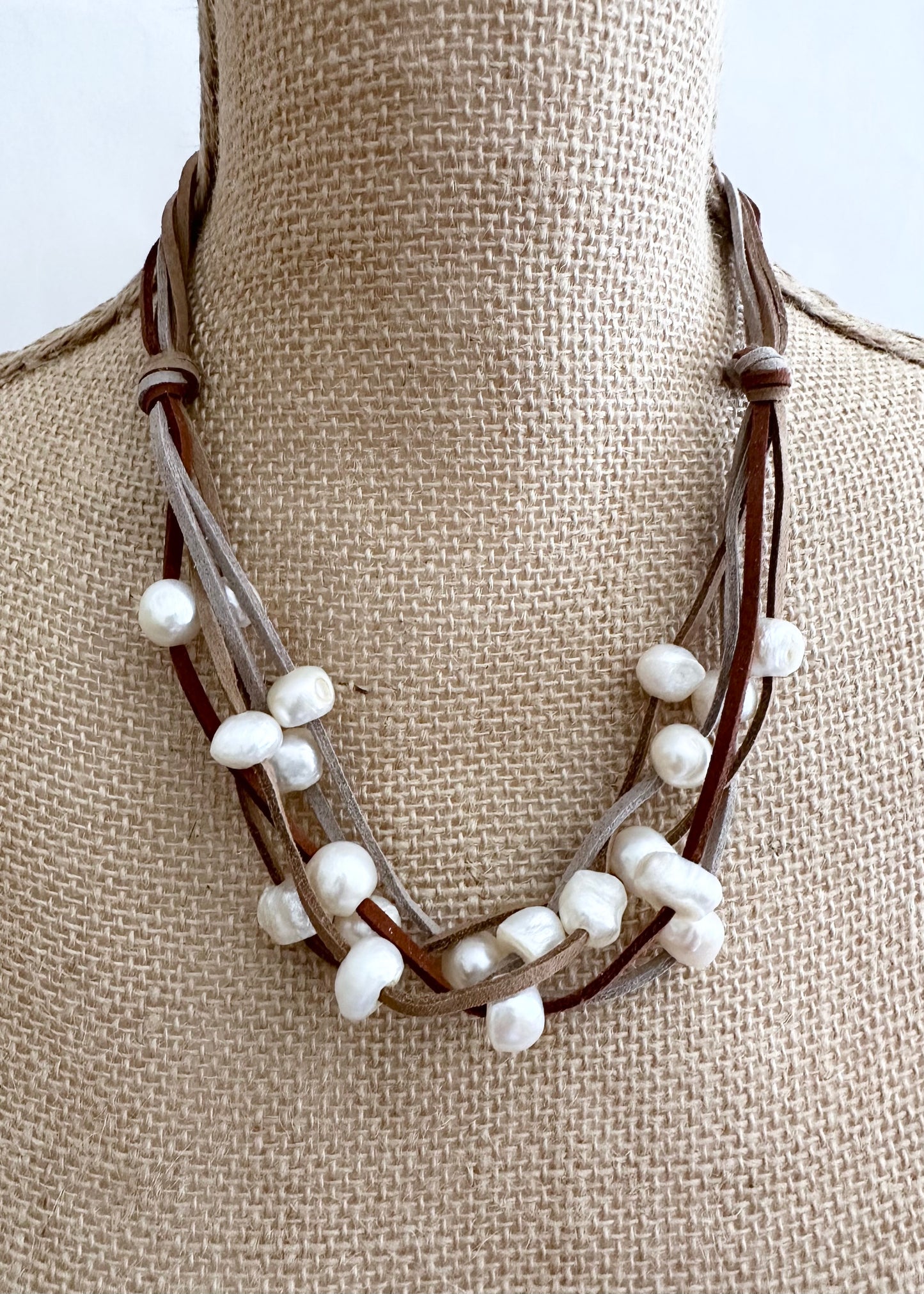 Five Strands of Brown Vegan Suede with Floating White Freshwater Pearls are Offered with a Strong Secure Magnetic Clasp for Easy Wear. On Bust