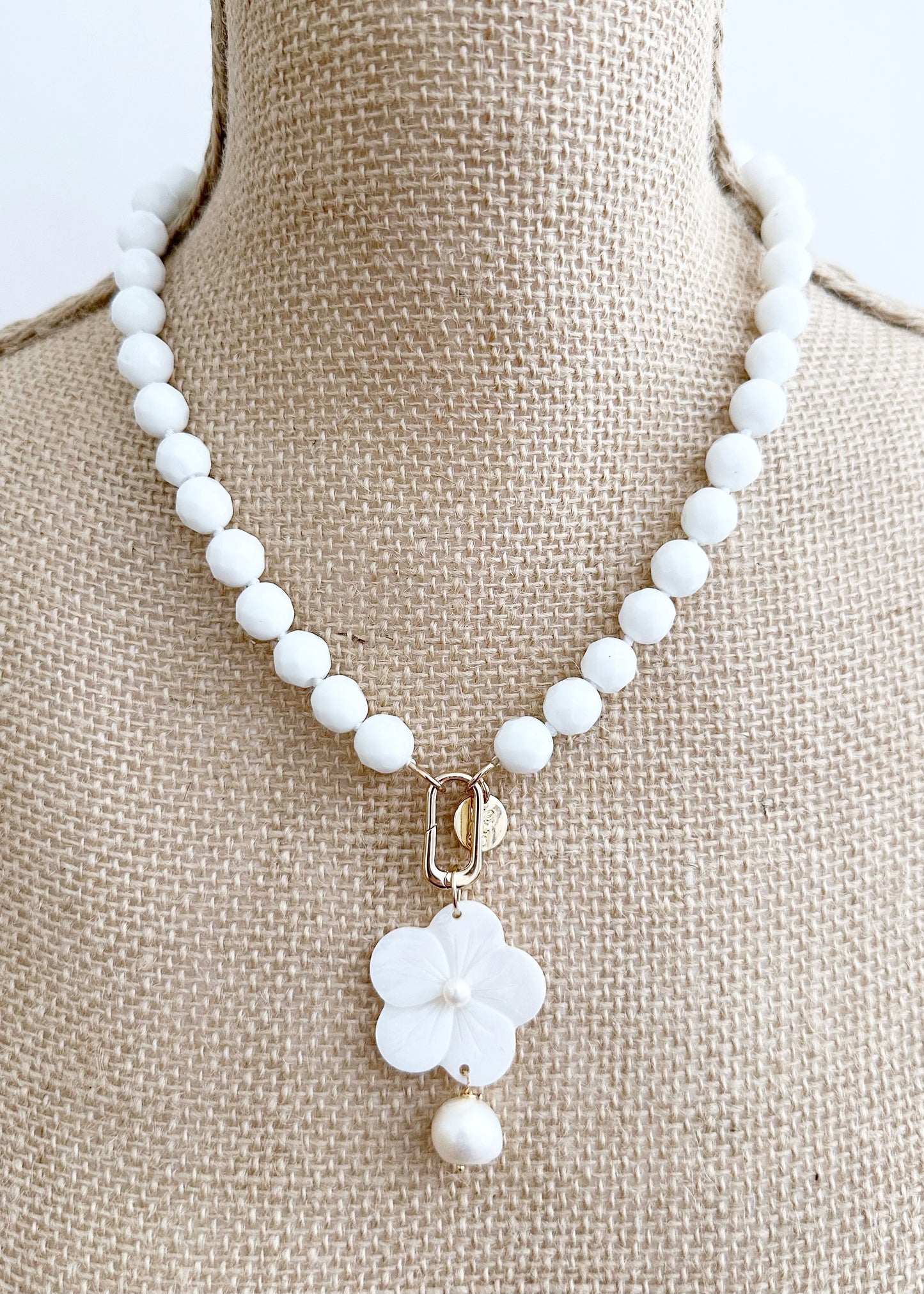 White Freshwater Baroque Pearls Strung with Faceted White Semi-Precious Stones with a Pretty Carved Shell Flower Pendant Hanging from a Gold-Plated Rectangular Clasp for a 18.5” Necklace.  This Necklace can be worn in Various ways.