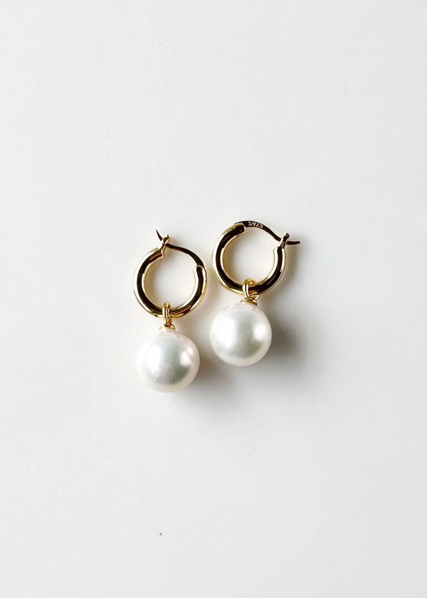 These Earrings feature Stunning Large (10-11mm) White Freshwater Pearls Elegantly Paired with Gold-Plated Hoops.