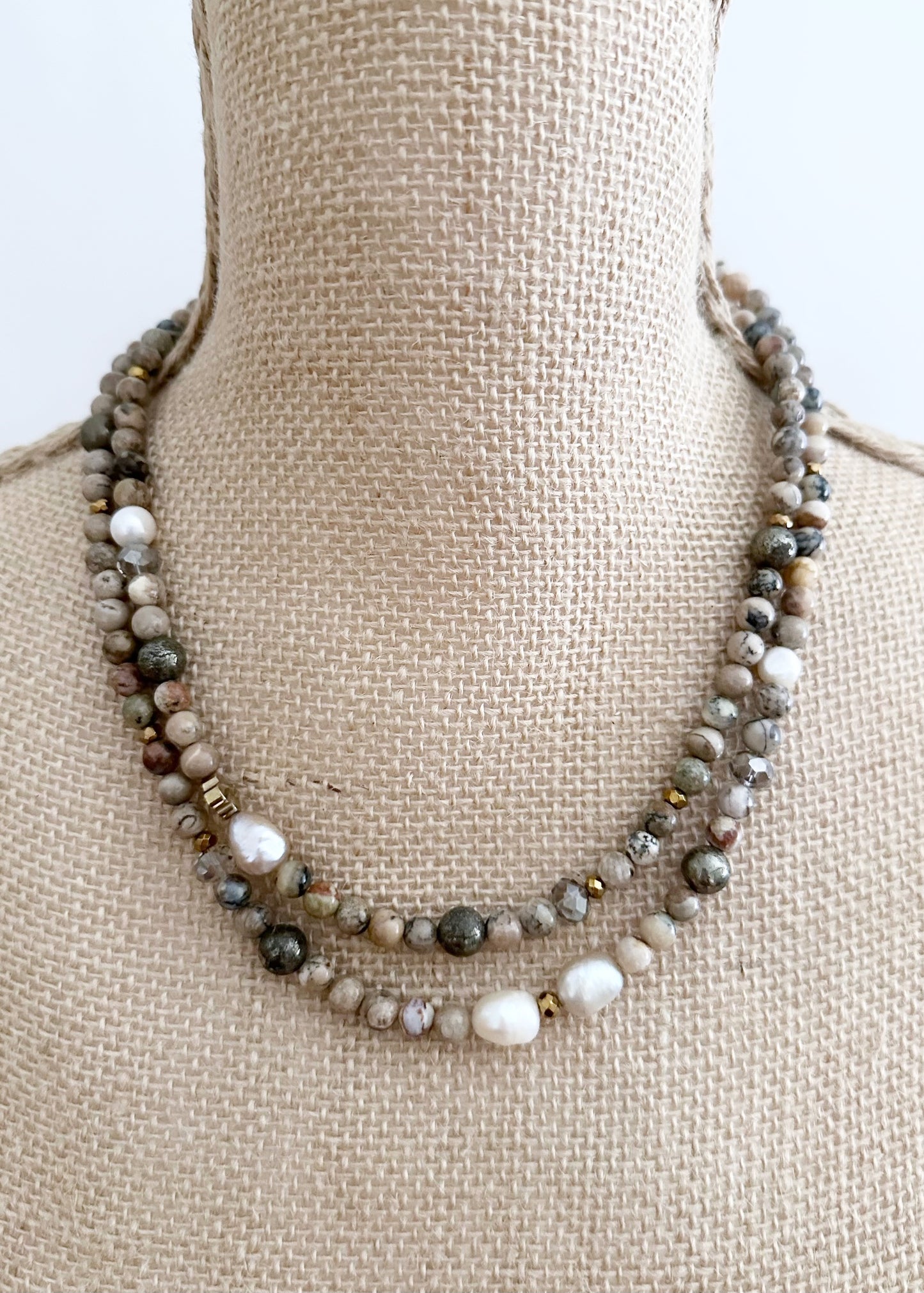 This Two-Strand (Inner Length of 19”) Necklace Features White African Opal and Freshwater Pearls Accented with Pyrite, Faceted Crystal and Gold-Plated Hematite for a soft elegant touch. Finished with a Magnetic Clasp for Easy Wear. Designed and made in Canada