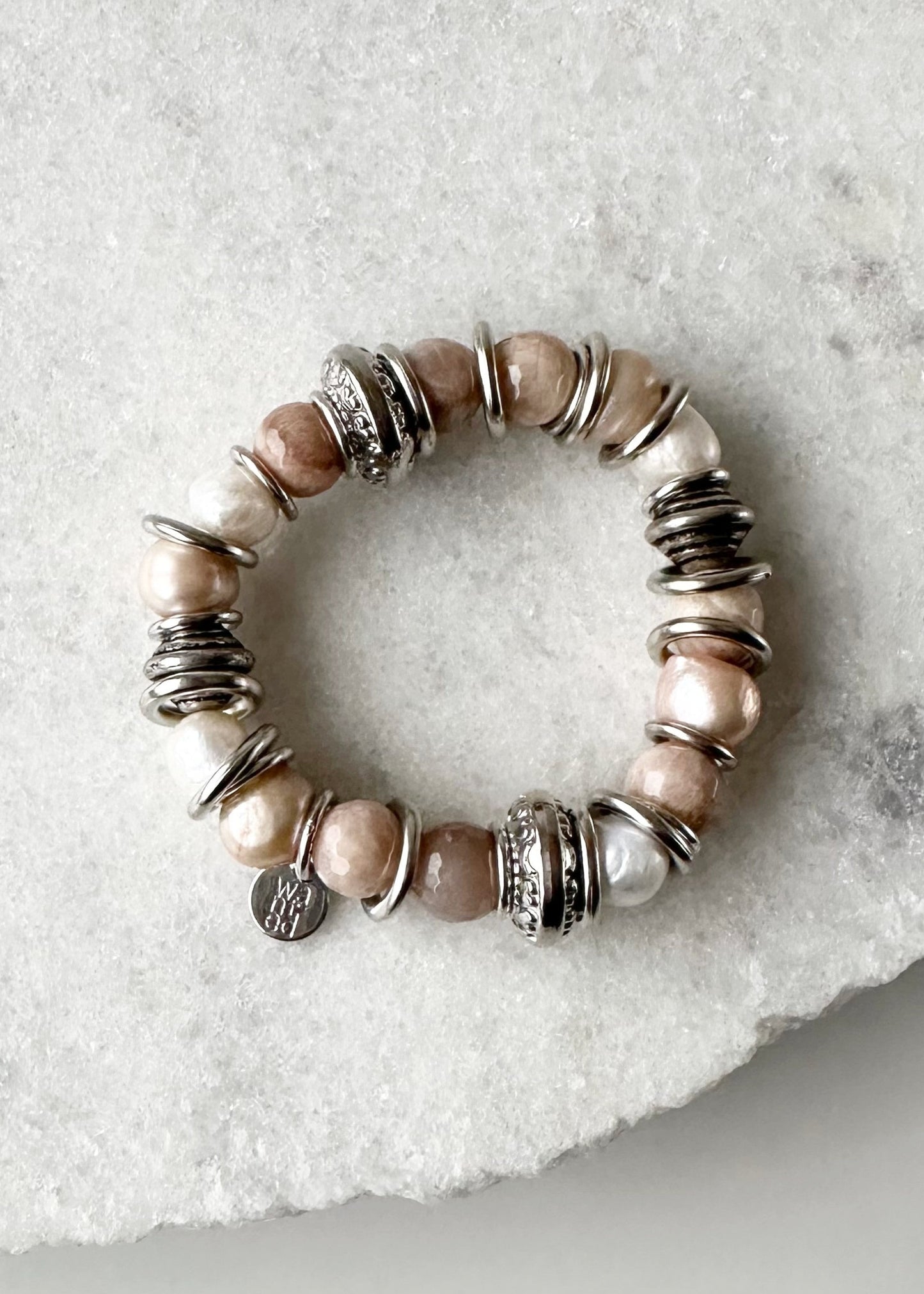 Lustrous Baroque Freshwater Pearls, Large Semi-Precious Stones, Metal Beads and Silver Bands make up this Stretch Bracelet (approx. 7”) in Three Different Colour Combinations. Peach and Taupe are Highlighted