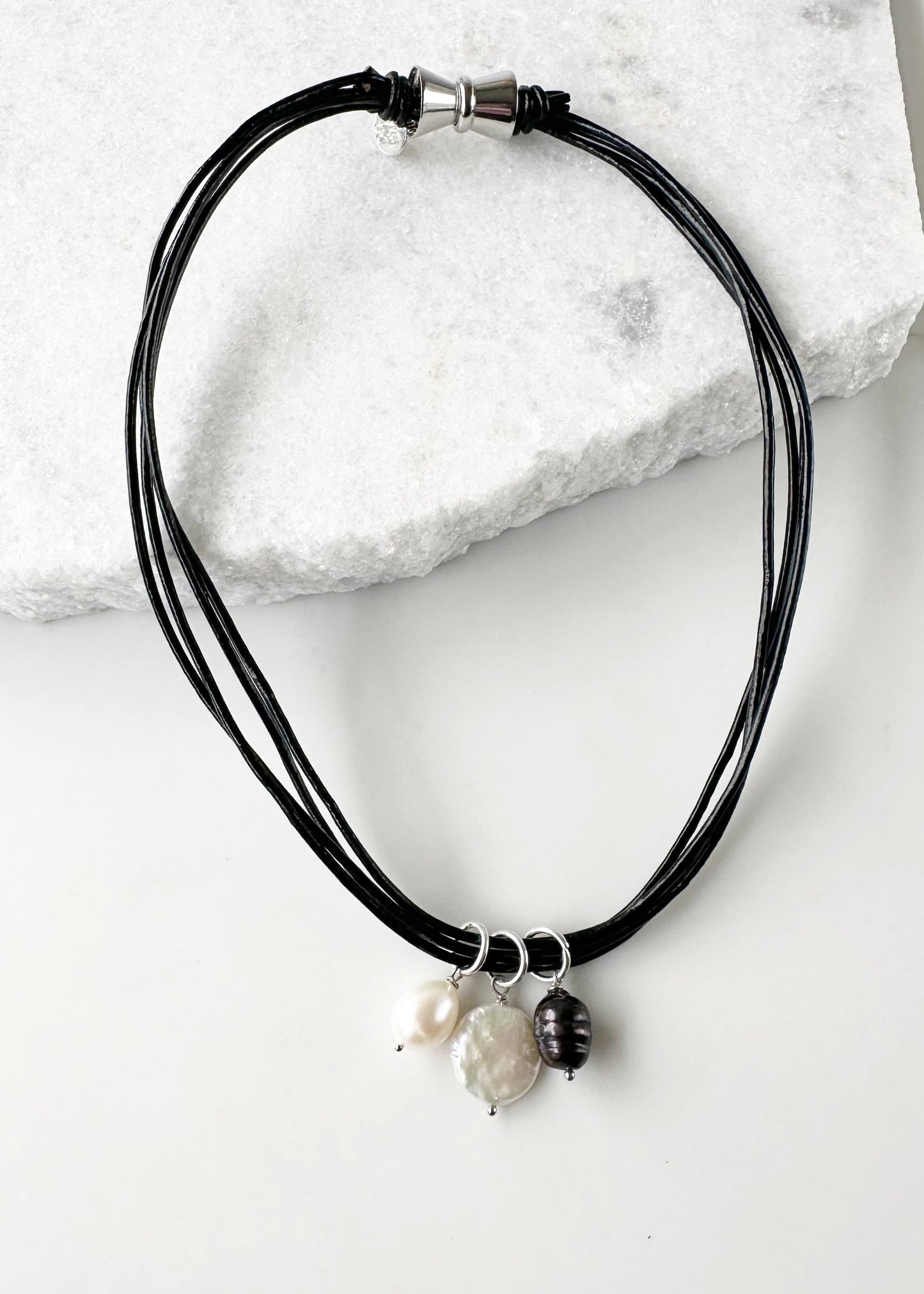 This 18.5” Necklace Features Three Beautiful Freshwater Pearls on Leather Cord to bring a subtle, elegant touch, Finished with a Magnetic Clasp for Easy Wear. Designed and Made in Canada