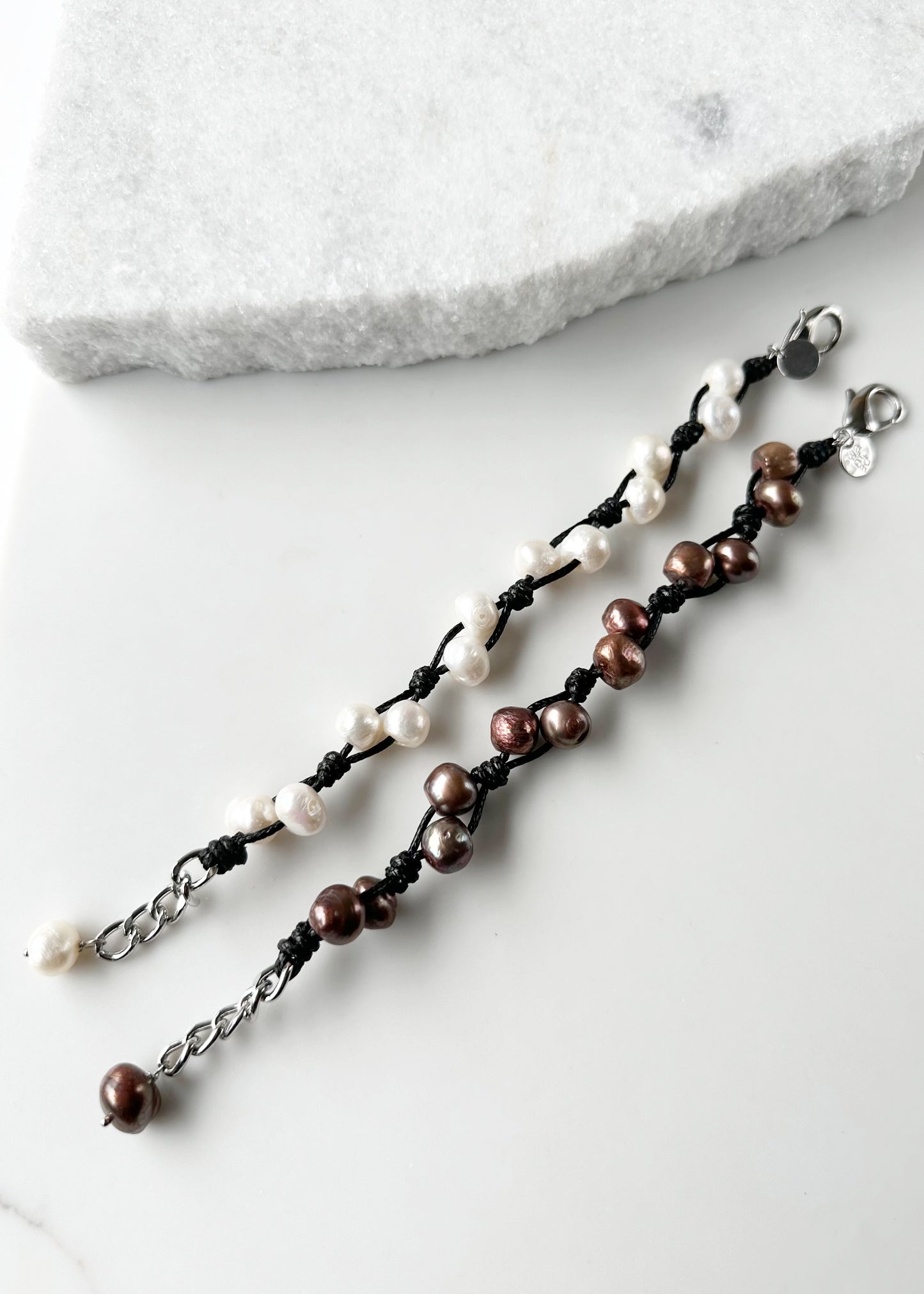 This 7.5” Bracelet Features Lustrous Freshwater Pearls Knotted on Cotton Cord,  Completed with a Large Lobster Claw Clasp and Extender Chain. Designed in Canada.