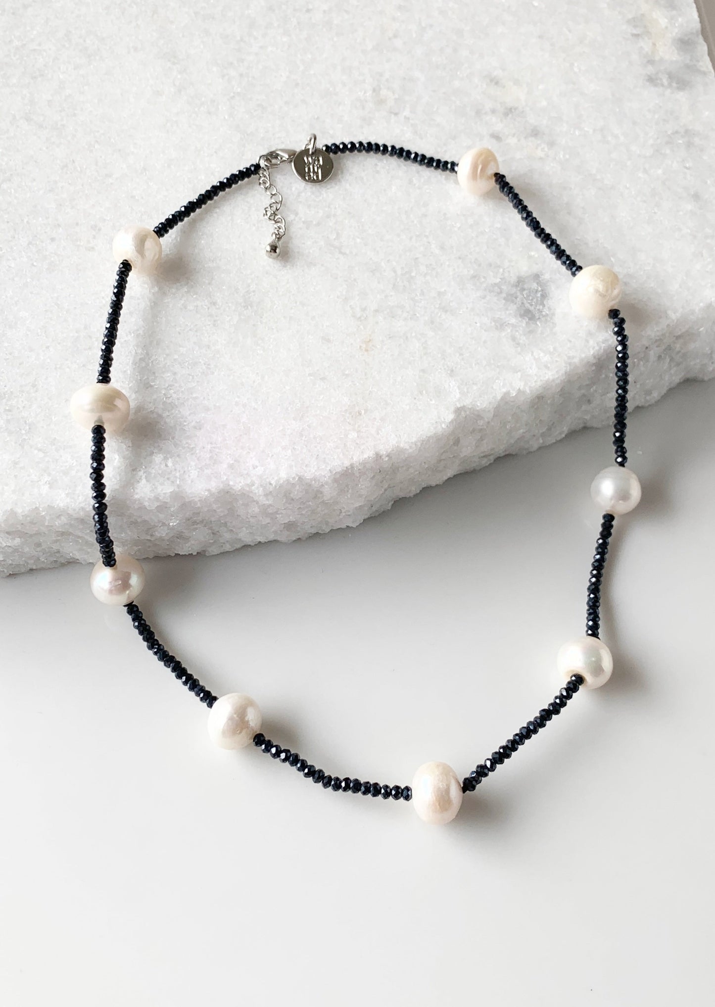 White Freshwater Pearls and Black (2mm) Faceted Crystals form this 18” Necklace with 1.5” Extender.  The Piece is finished with a Lobster Claw Clasp.