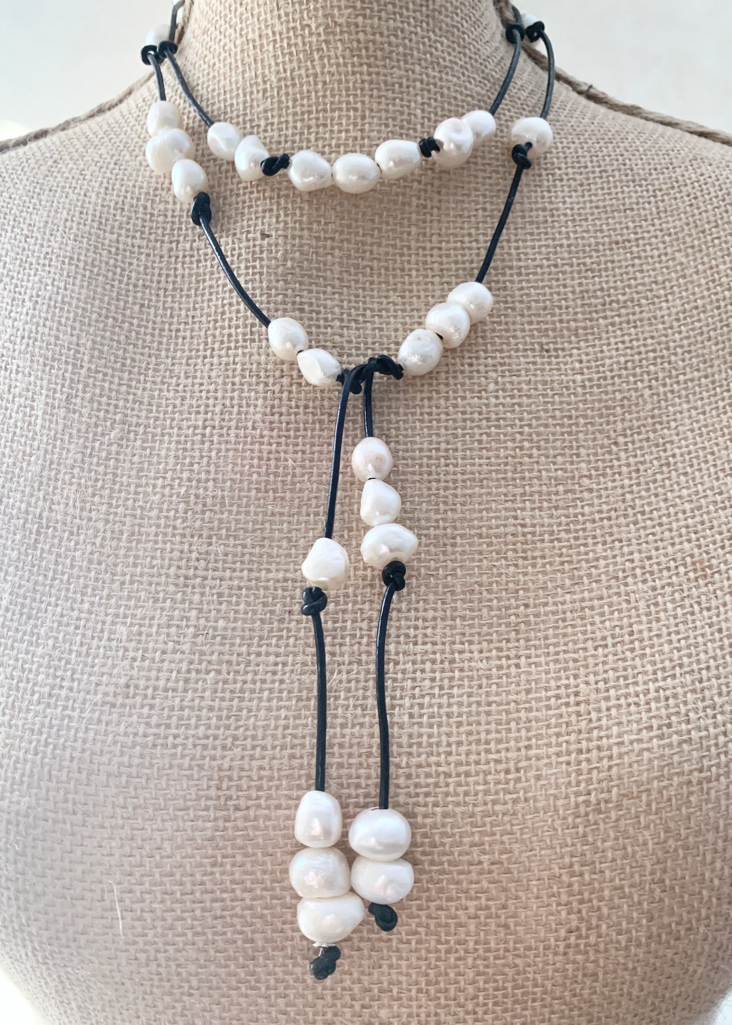 Long 46” Black Leather Lariat Adorned with Lustrous White Freshwater Pearls.  Can be worn Long, Doubled and in a Variety of Ways to Suit your Personal Taste and Mood. ne Creative way to Wear, on Bust