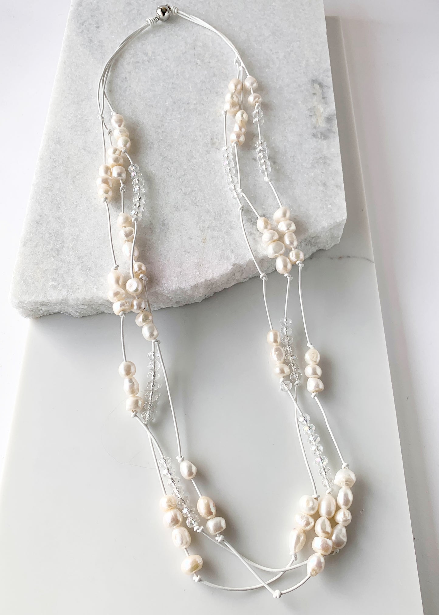 White Baroques Freshwater Pearls and White Faceted Crystals on White Knotted Leather For a Long  39” Necklace with Strong Secure Magnetic Clasp for Easy Wear.