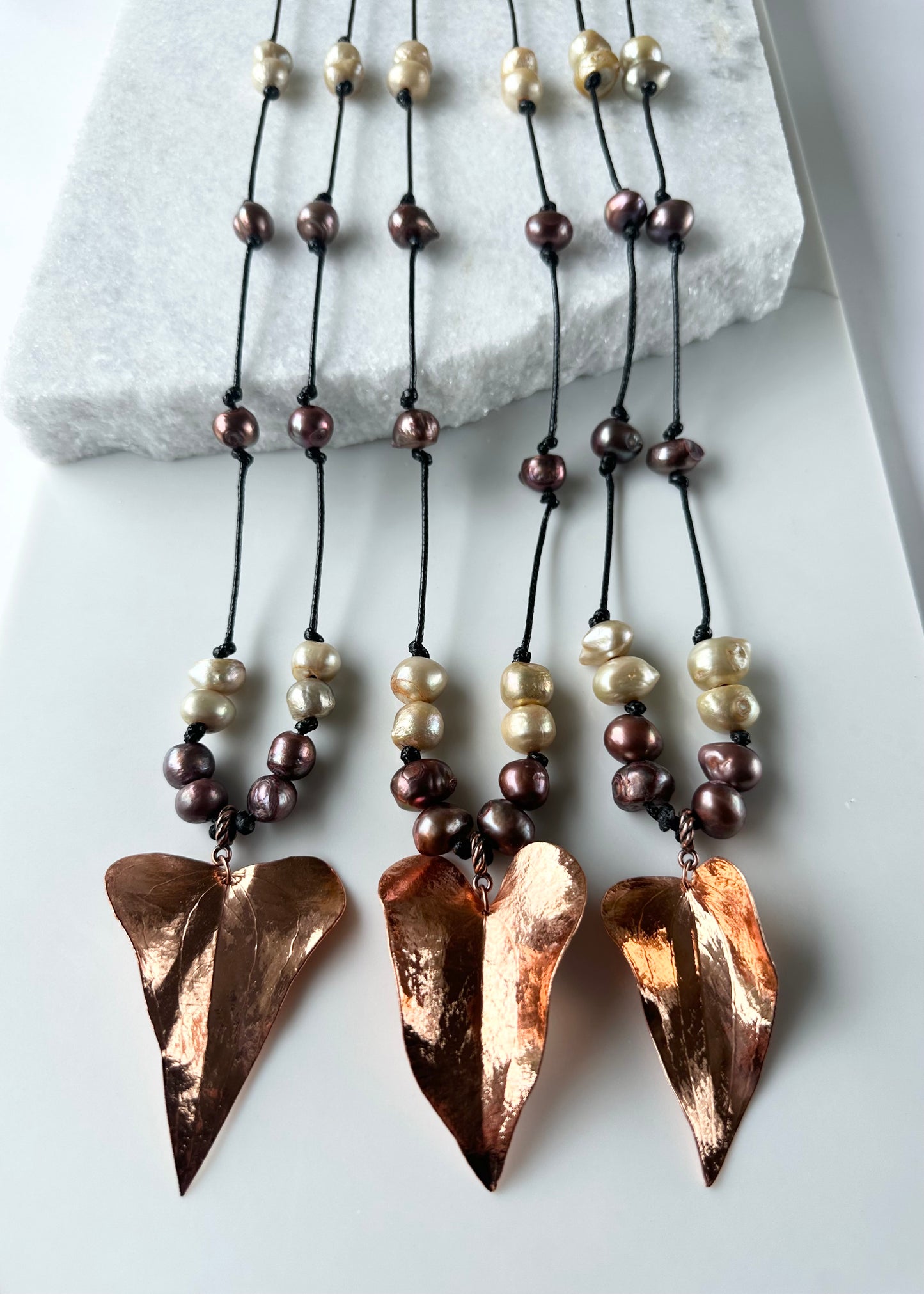 Beautiful Brown and Gold Baroque Freshwater Pearls Knotted on Black Cotton Cord with a Large Light  Copper Leaf Pendant. Three Shown.