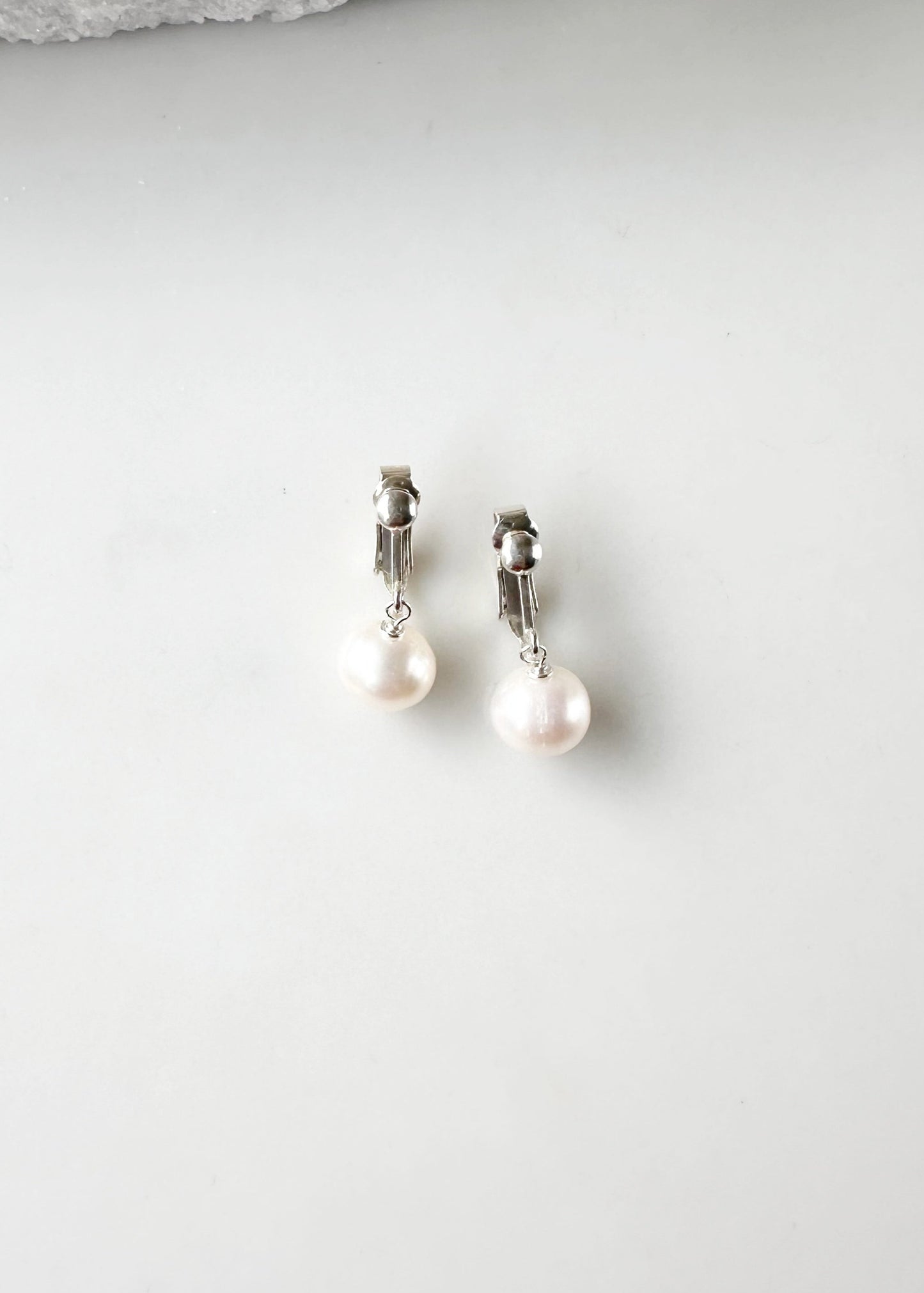 This Elegant Clip-On Earring Features a Beautiful Freshwater White 10mm Pearl Drop on Sterling Silver. Designed and made in Canada