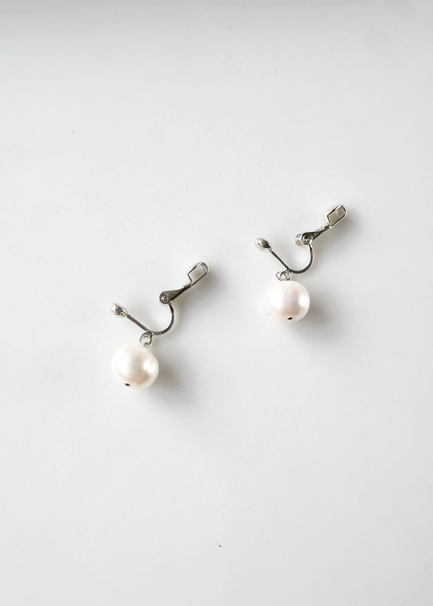 This Elegant Clip-On Earring Features a Beautiful Freshwater White 10mm Pearl Drop on Sterling Silver. Designed and made in Canada