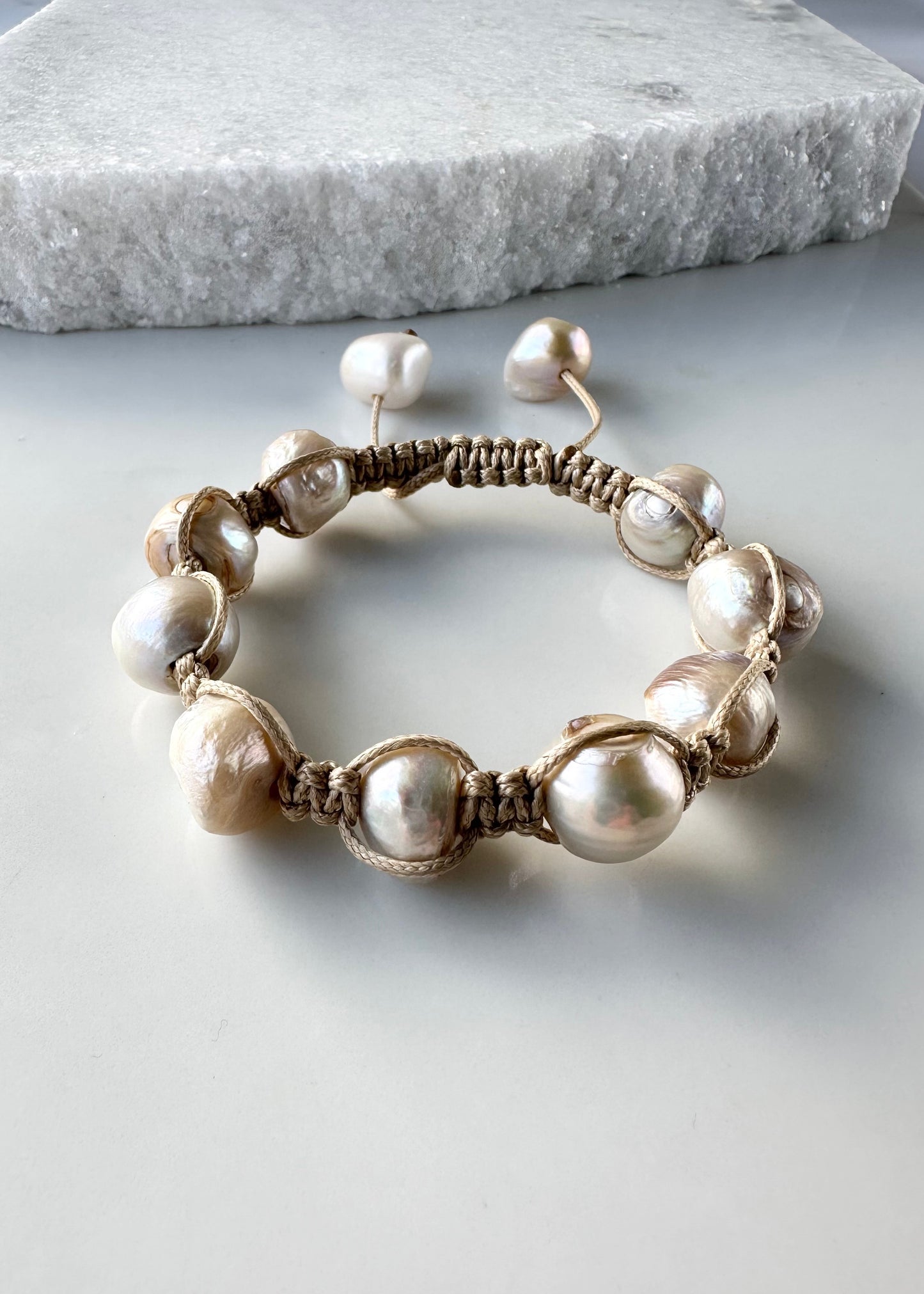 Nine Large Champagne Baroque Freshwater Pearls on Beige Knotted Cord Plus Sliding Knot Closure with Two Smaller Pearls to Offer Adjustable Length.