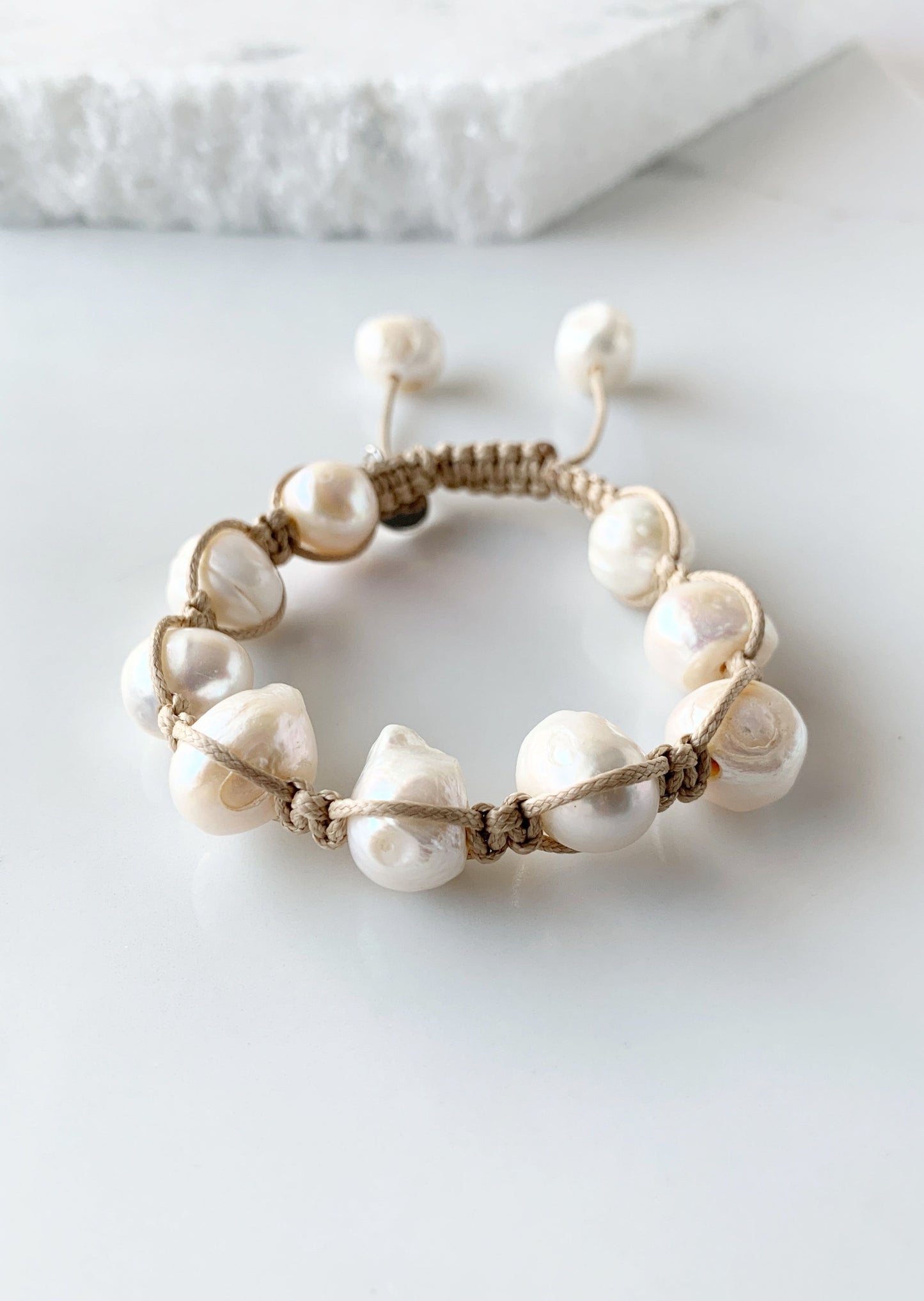 Nine Large White Baroque Freshwater Pearls on Beige Knotted Cord Plus Sliding Knot Closure with Two Smaller Pearls to Offer Adjustable Length.