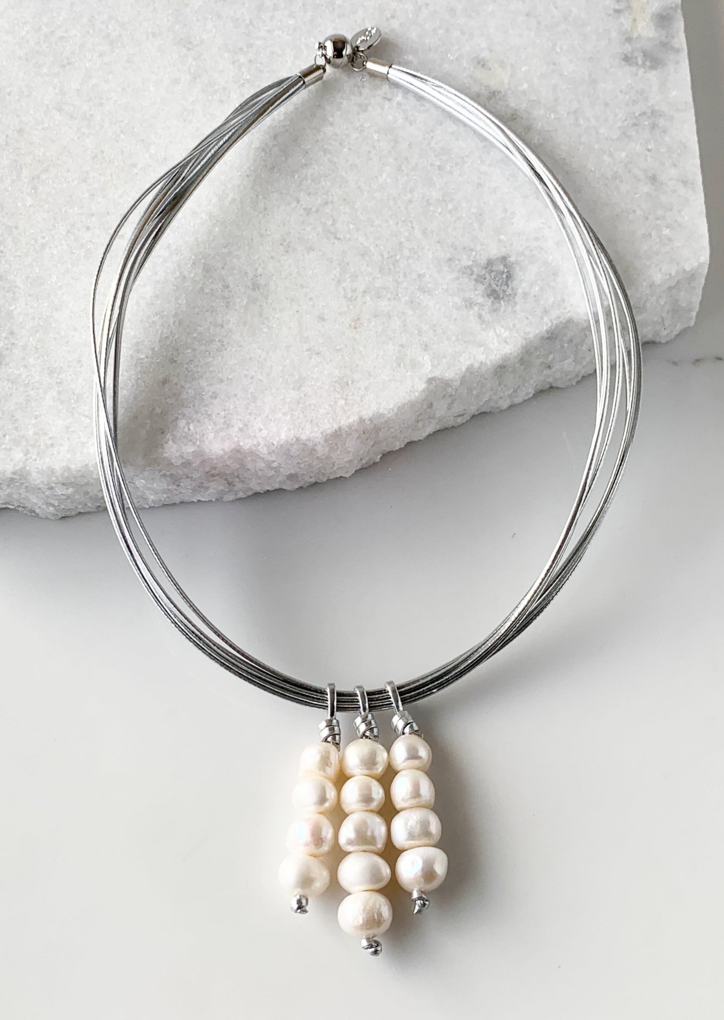 Three Stacks of White Baroque Freshwater Pearls on Silver Metal Cord Make Up this Necklace with a Strong Secure Magnetic Clasp for Easy Wear.
