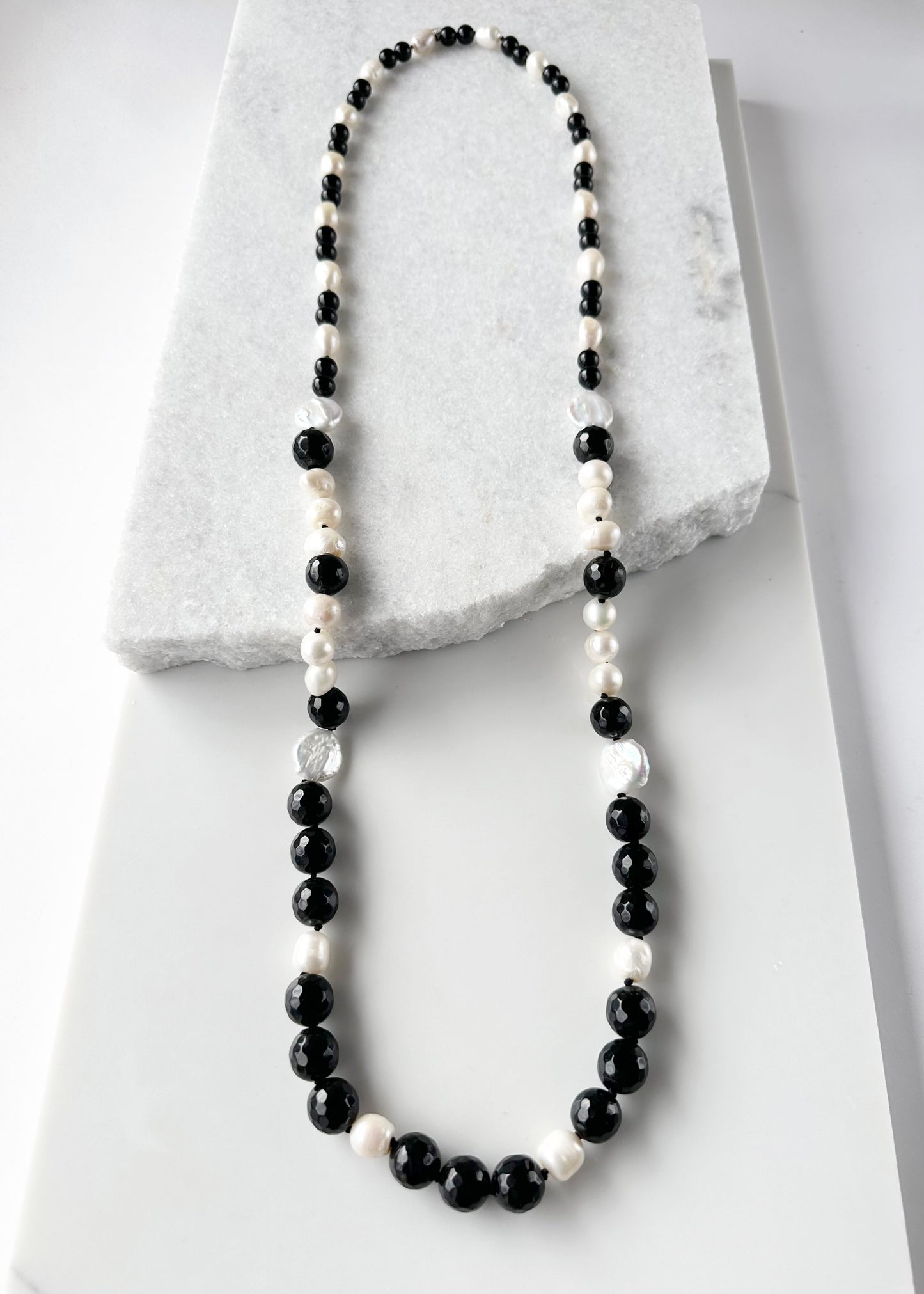Large White Baroque and Coin Freshwater Pearls Adorn this Necklace with 8-14mm Faceted Black Agate.