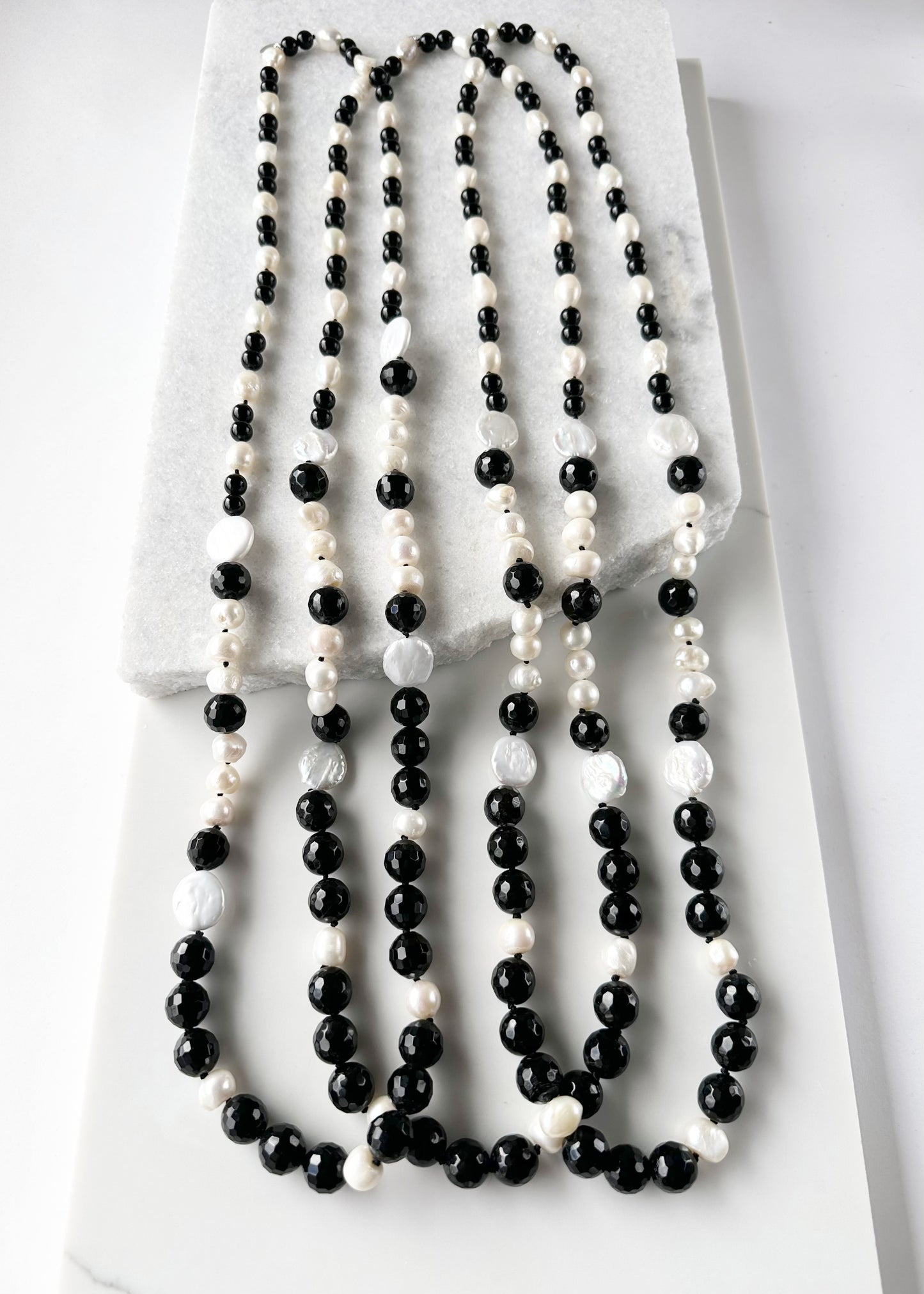 Large White Baroque and Coin Freshwater Pearls Adorn this Necklace with 8-14mm Faceted Black Agate. Three Shown