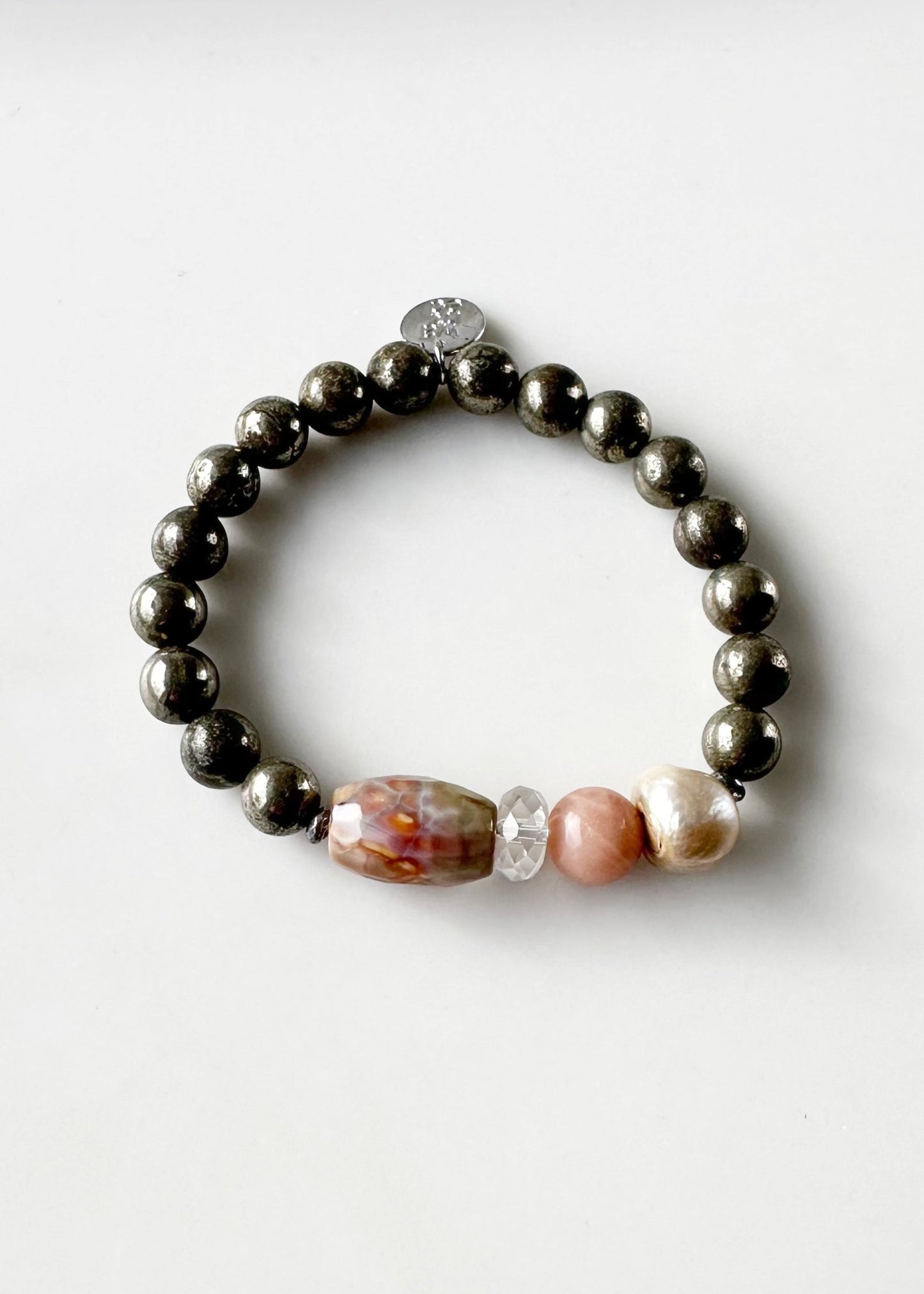 •	Fitting up to a 7” wrist, this Limited Edition Stretch Bracelet Boasts 8mm Pyrite, Freshwater Pearl, Moonstone, Quartz, Agate and Hematite.