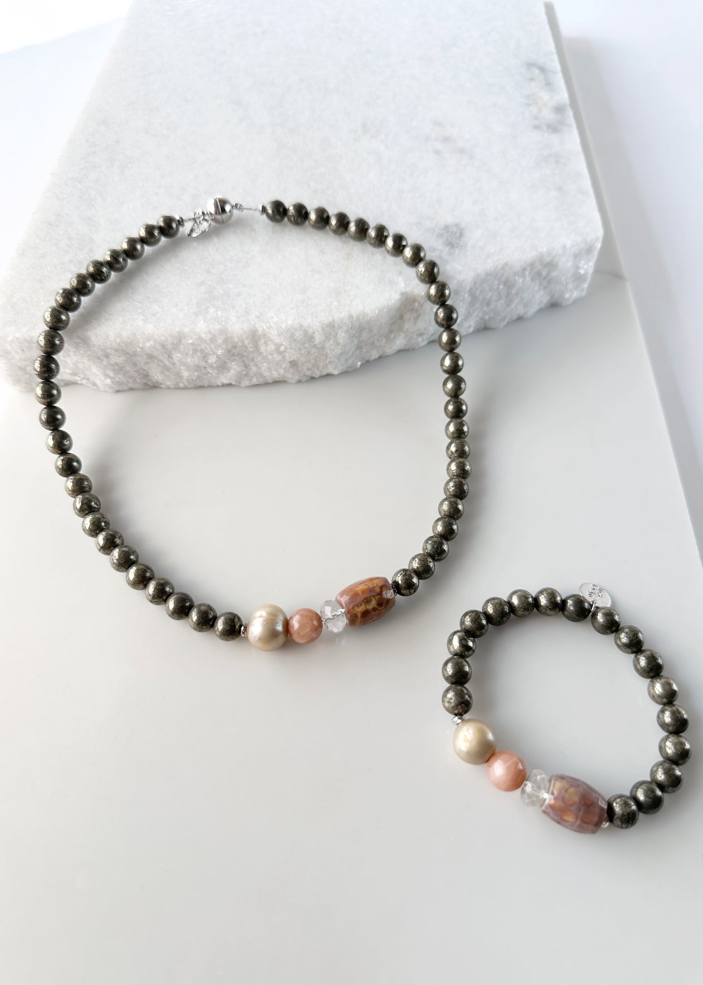 •	Fitting up to a 7” wrist, this Limited Edition Stretch Bracelet Boasts 8mm Pyrite, Freshwater Pearl, Moonstone, Quartz, Agate and Hematite. Matching Polly Necklace