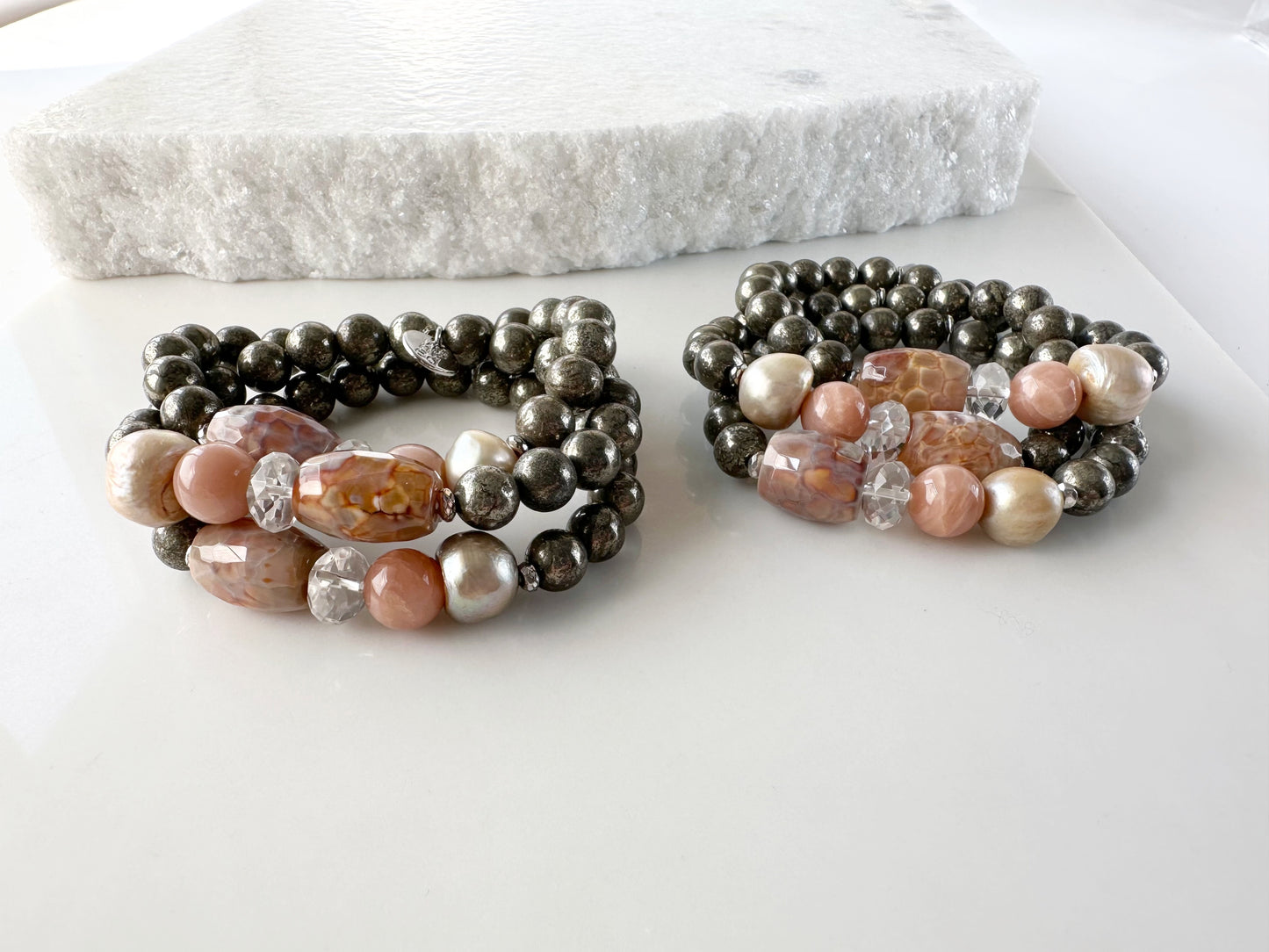 •	Fitting up to a 7” wrist, this Limited Edition Stretch Bracelet Boasts 8mm Pyrite, Freshwater Pearl, Moonstone, Quartz, Agate and Hematite. Two Shown