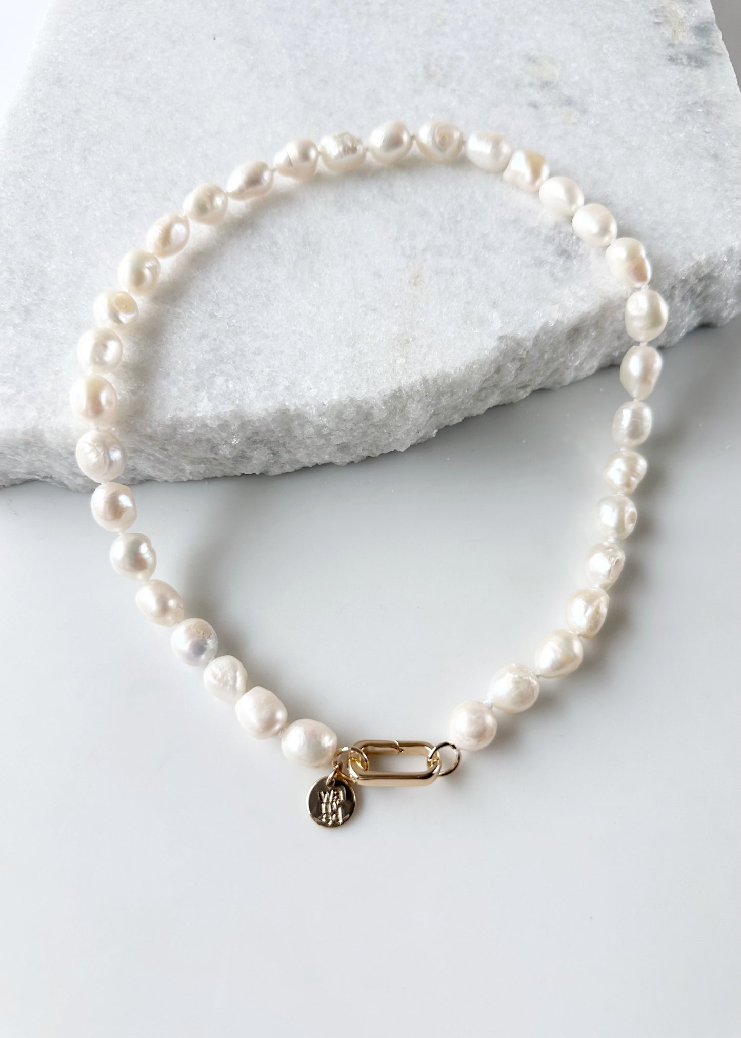 Lustrous Baroque Freshwater Pearls are Knotted in White with a Gold Charm Clasp to Place your Favorite Pendants.  And Wear the 18.5” Necklace in Reverse to show off the Classic Pearls.