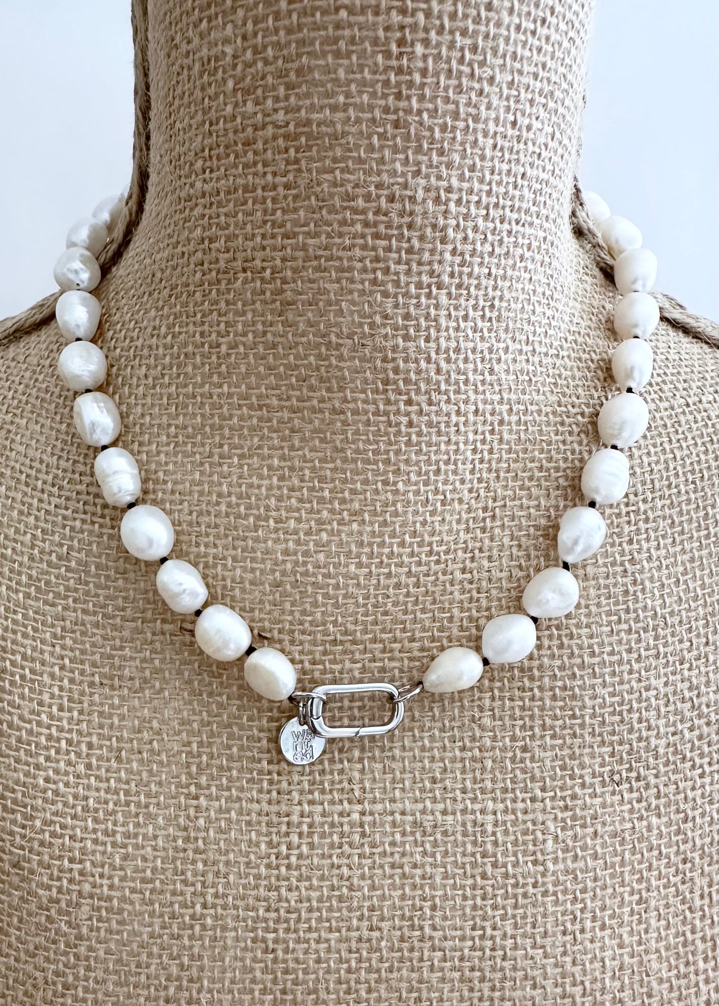 Lustrous Baroque Freshwater Pearls are Knotted in Black with a Silver Charm Clasp to Place your Favorite Pendants.  And Wear the 18.5” Necklace in Reverse to show off the Classic Pearls. On Bust